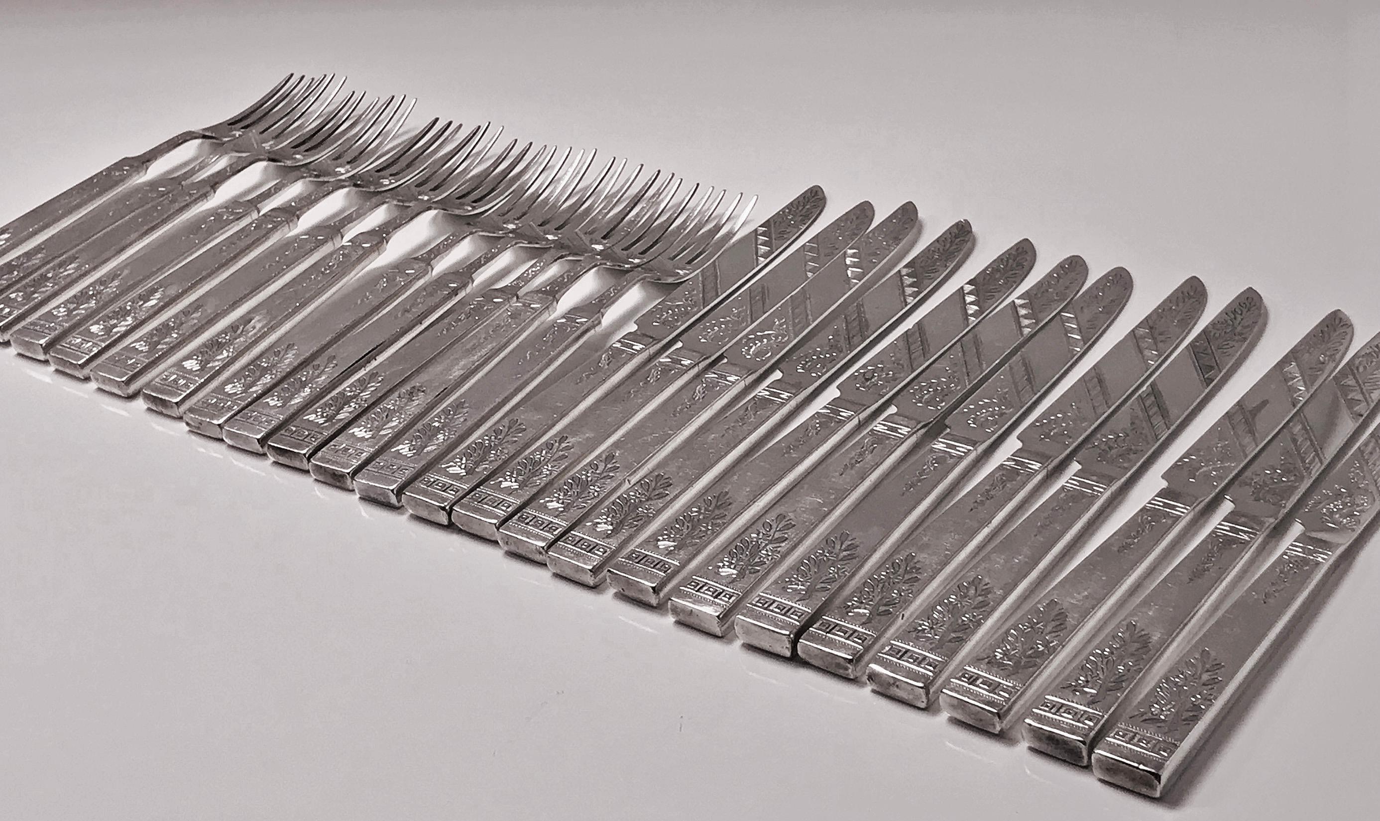 Set of 24 Antique English Silver Plate Lunch Dessert knives and forks, C.1853, Martin Hall & Co. The Service comprises 12 knives and 12 forks, tapered quadrilateral handles; the handles, tines and blades all engraved with stylised foliate, wriggle