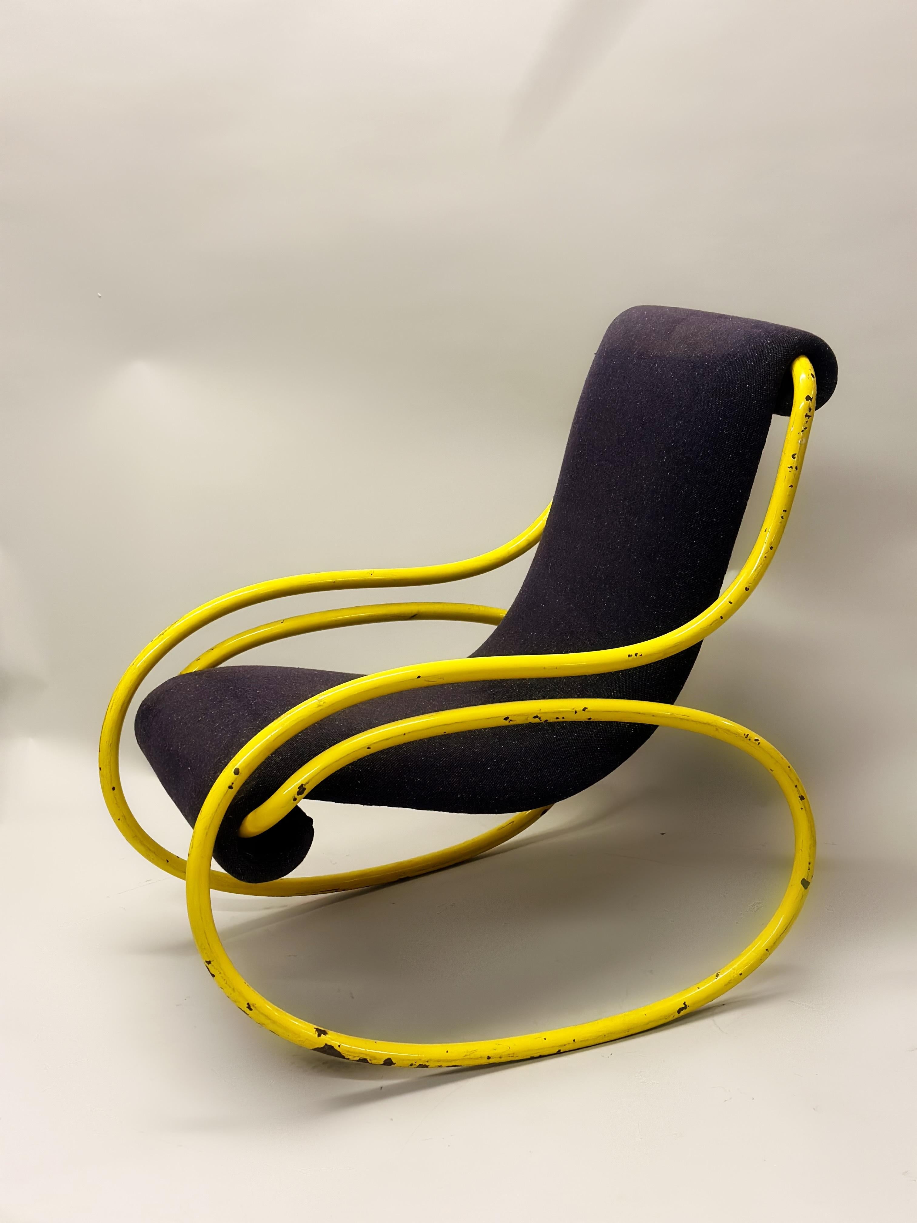 A Rare Italian MId-Century Modern Rocking Chair or Lounge Chair Attributed to Gae Aulenti. The chair is an original piece of 1960's midcentury design and possesses a strong organic modern sensibility with it's revolving steel structure. It has it's