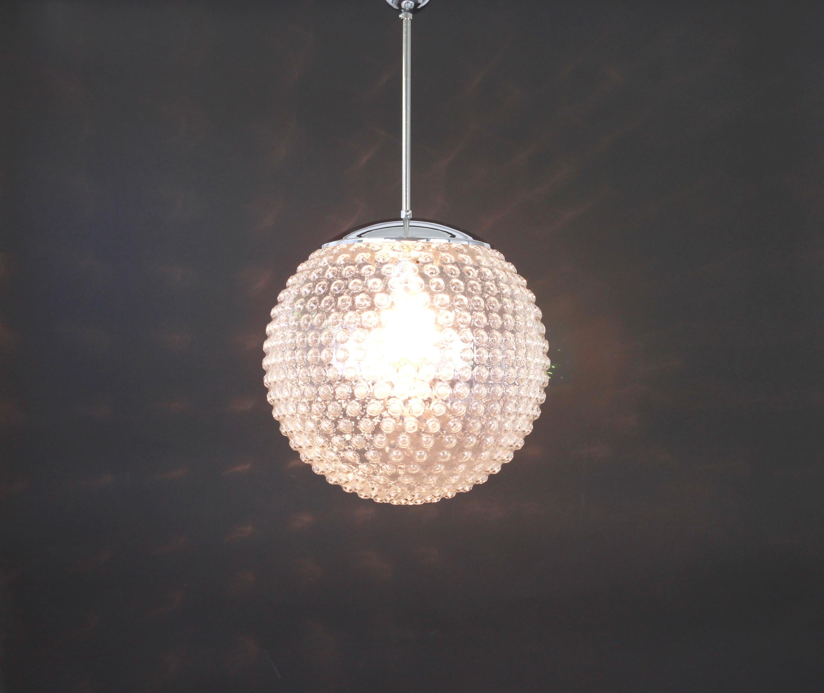 Rare designer glass pendant lamp by Rolf Krüger for Staff, Germany, 1970s, Germany, circa 1970-1979.

Sockets: One x E27 standard bulb (max. 100 Watts) and compatible also with the US standards

Measures: Diameter 33 cm // 13 inches
Height
