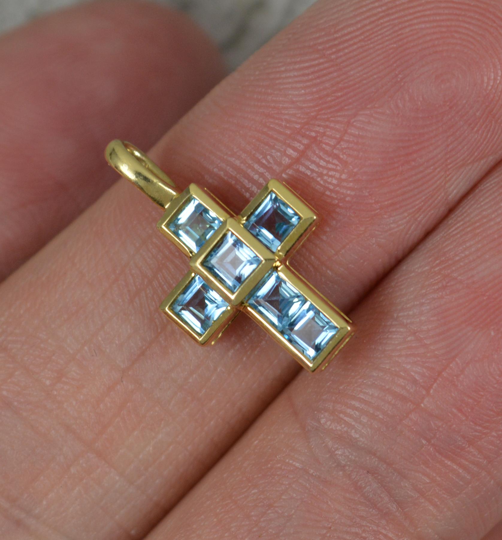 A superb piece by Theo Fennell.
Solid 18 carat yellow gold example.
Cross shape with six princess cut blue topaz stones.
A sweet charm / pendant.

CONDITION ; Excellent. Beautiful example. Polished. Please view photographs.
WEIGHT ; 1.5 grams all