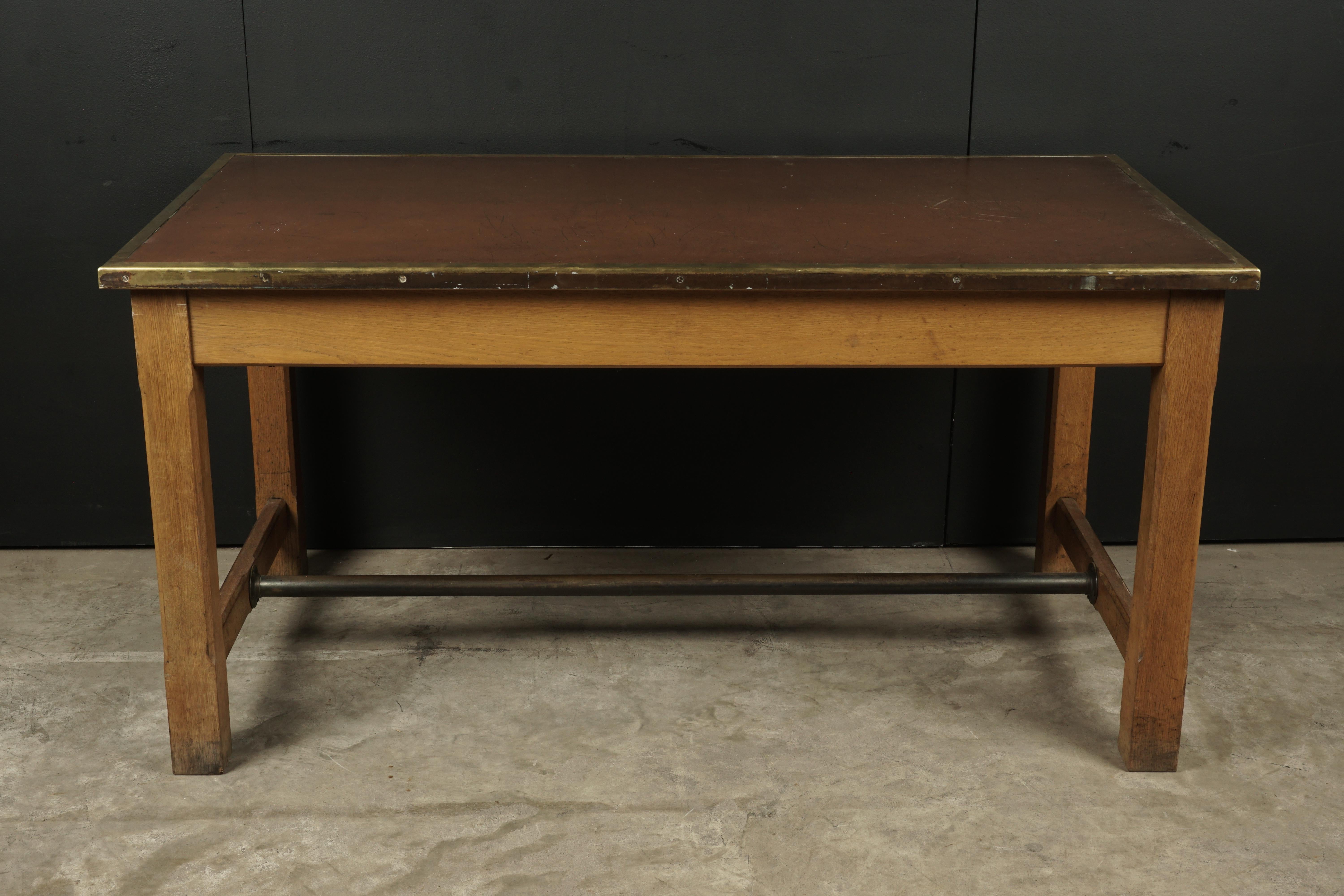 Rare Desk from the Banque De France, circa 1950. Solid oak construction with a thick sort of vinyl top and brass edge detail.