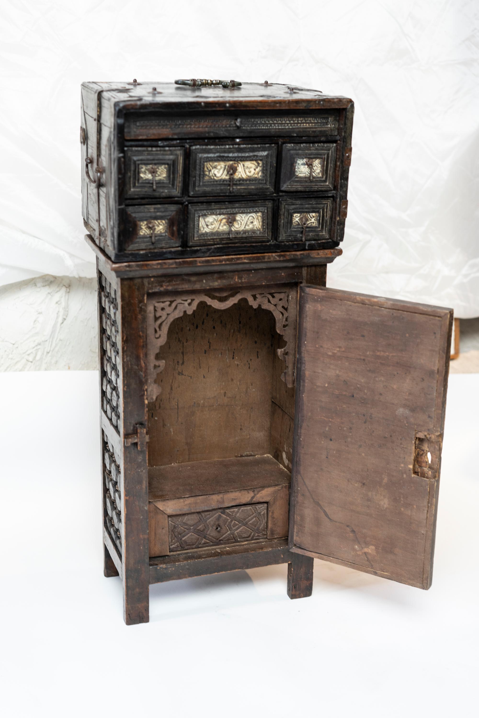 Rare diminutive Hispano Mauresque vargueno cabinet inlaid with bone and the interior fitted with forged iron hardware missing fall front panel, beautiful antique weathered patina. Together with later cabinet stand.
