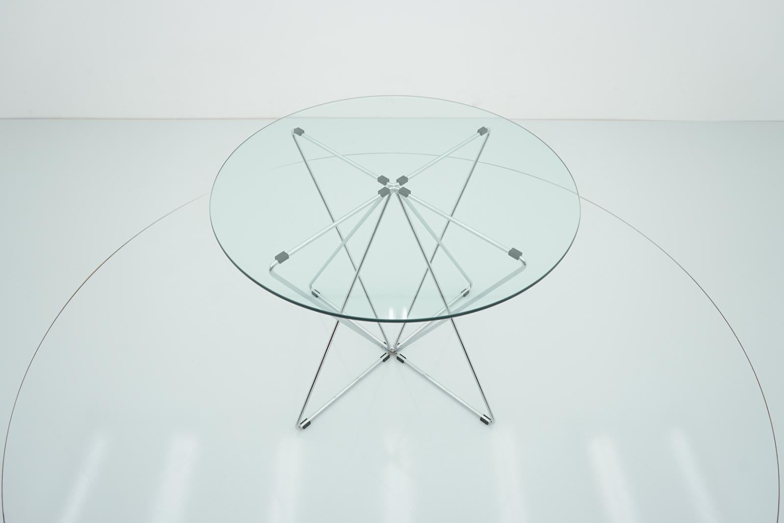 Rare glass and chromed steel dining table by Till Behrens, Schlubach Germany 1983.
The base is signed.
Very good condition.
     
