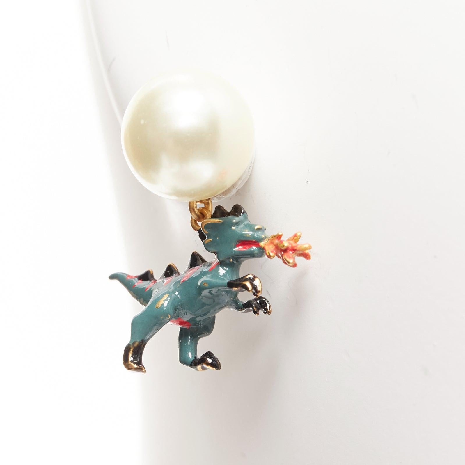 rare DIOR Tribale pearl green dragon dinosaur charm pin earrings pair
Reference: AAWC/A00915
Brand: Dior
Designer: Maria Grazia Chiuri
Material: Metal, Faux Pearl
Color: Pearl, Green
Pattern: Animal Print
Closure: Pin
Lining: Gold