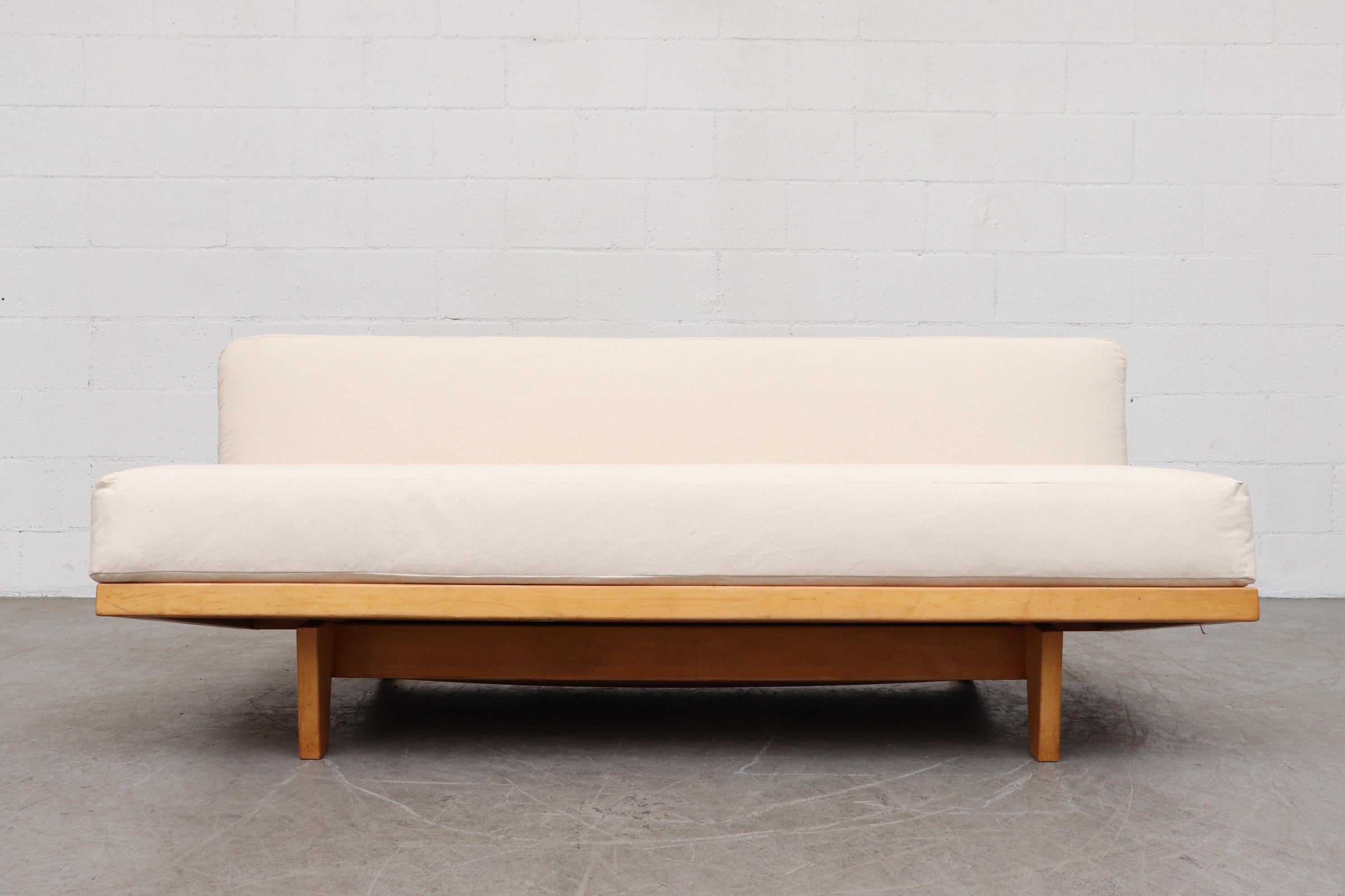 Stunning original sit and sleep nodel MB09 couch with hidden blanket storage. Birchwood with new two-tone webbing similar to the original. Designed by Dirk van Sliedregt in 1951 for UMS Pastoe Holland, in Production until 1954. Newly upholstered in