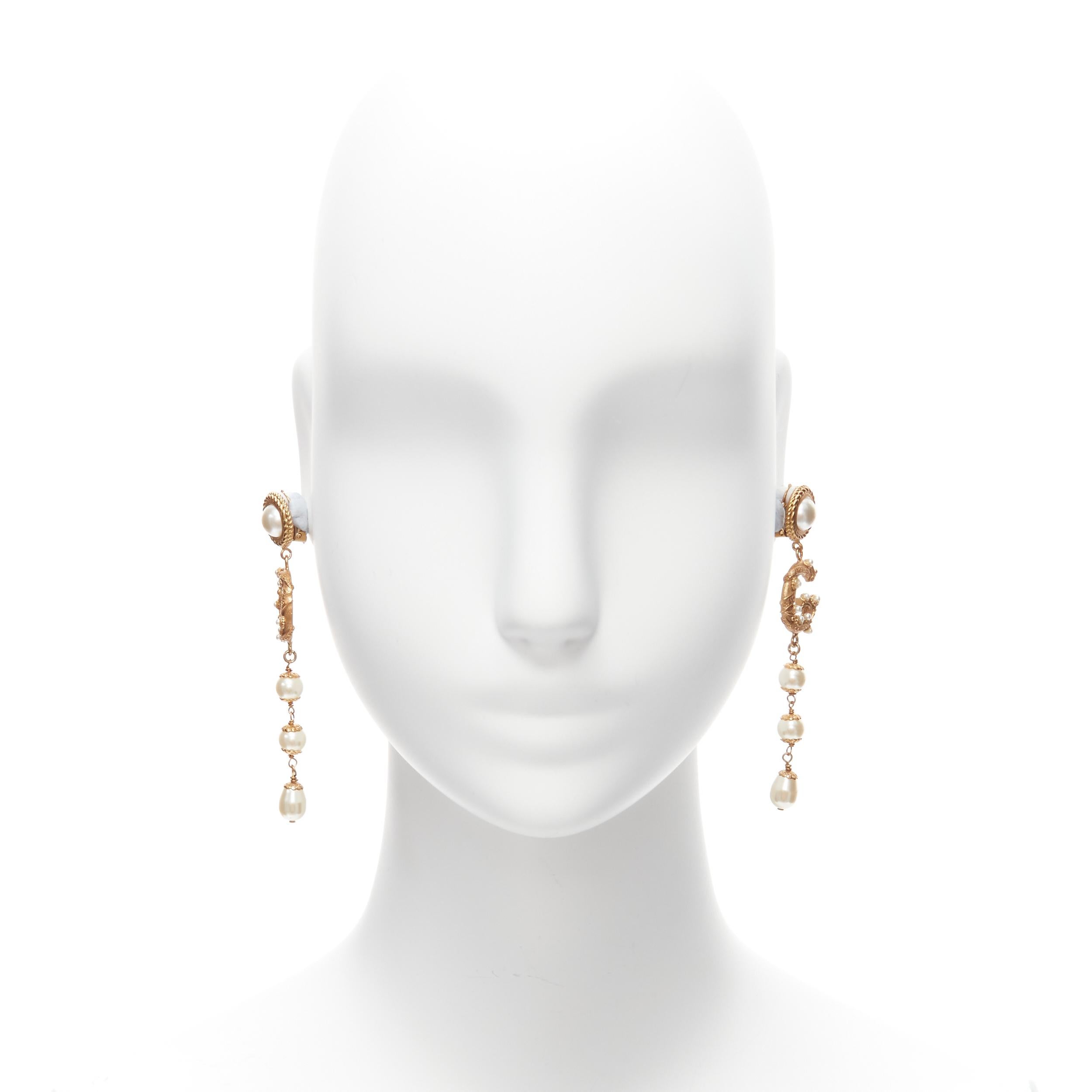 rare DOLCE GABBANA gold tone DG logo baroque pearl tiered drop clip earrings
Reference: TGAS/D00185
Brand: Dolce Gabbana
Designer: Domenico Dolce and Stefano Gabbana
Material: Metal, Faux Pearl
Color: Gold, Pearl
Pattern: Solid
Closure: Clip