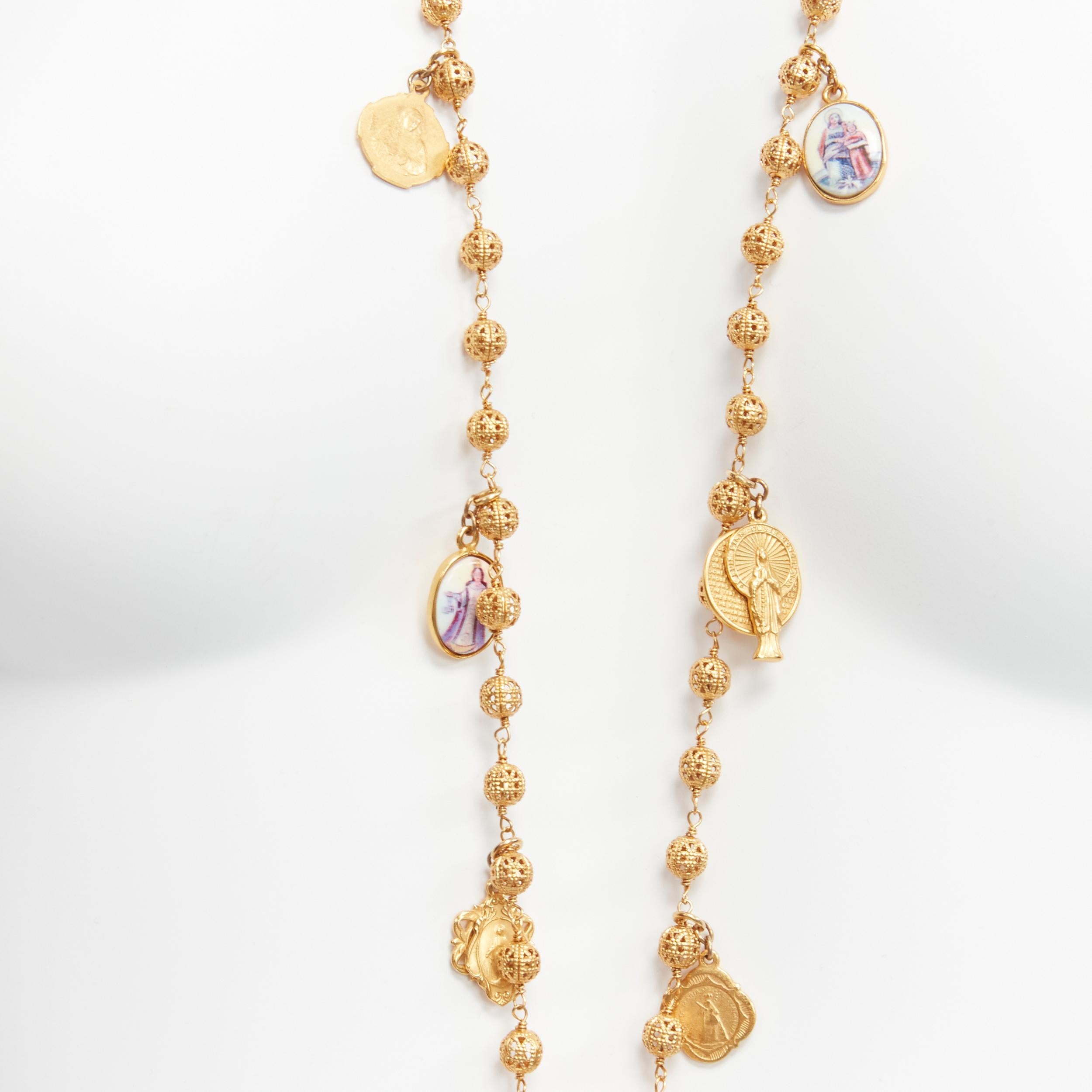 Women's rare DOLCE GABBANA gold tone Jesus cross Saints coin charm long rosary necklace