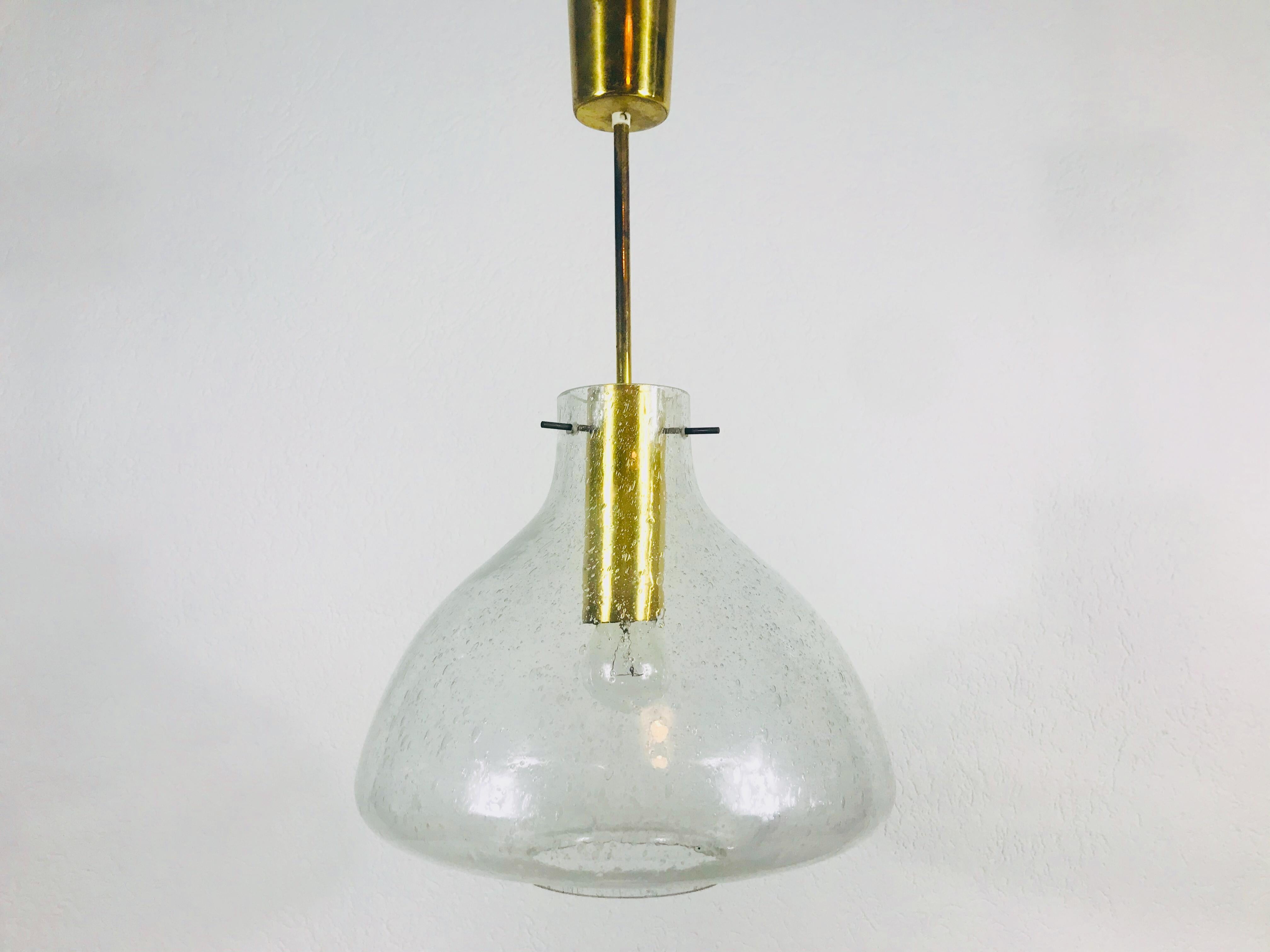 Une lampe suspendue en verre de glace Doria fabriquée en Allemagne dans les années 1960. Il est fascinant avec sa forme de verre rare. Un corps en laiton avec une barre en laiton. 

La hauteur est réglable de 55 à 70 cm.

Le luminaire nécessite