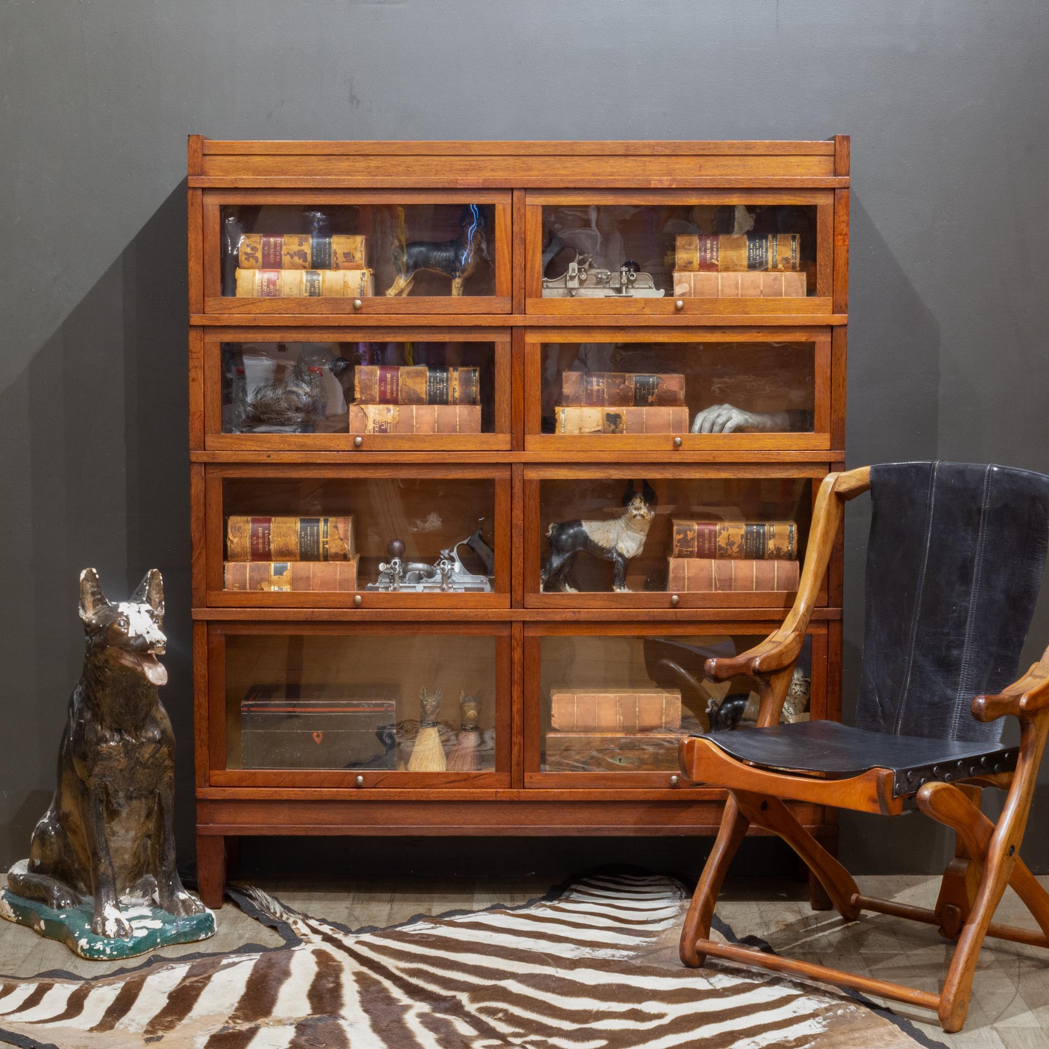 ABOUT

A rare double 4 stack lawyer's bookcase with a Mahogany finish, large brass knobs and graduating drawers. Eight independent doors that open and slide in properly. 

The whole piece is modular consisting of 6 pieces: the top, the bottom and