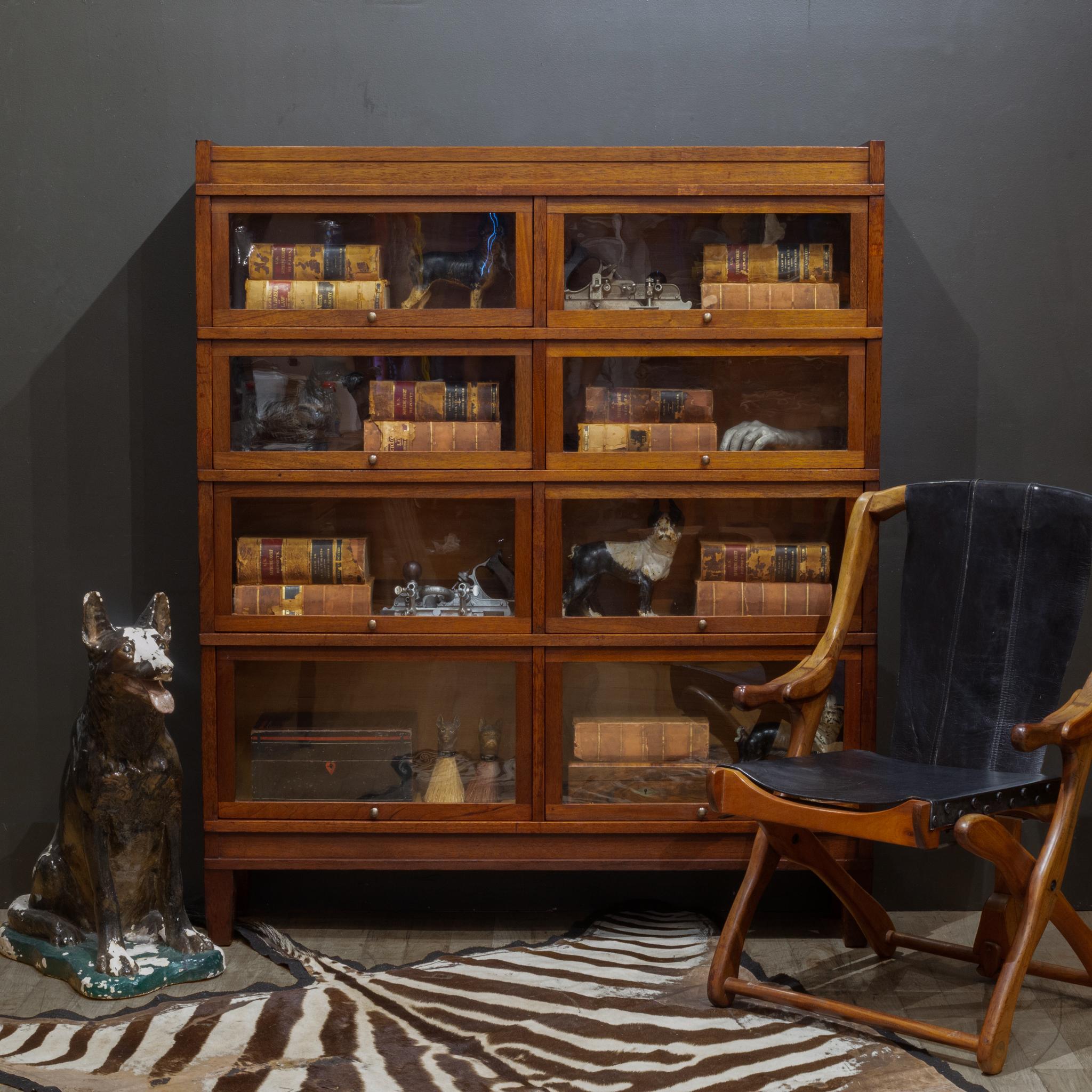 ABOUT

A rare double 4 stack lawyer's bookcase with a Mahogany finish, large brass knobs and graduating drawers. Eight independent doors that open and slide in properly. 

The whole piece is modular consisting of 6 pieces: the top, the bottom and
