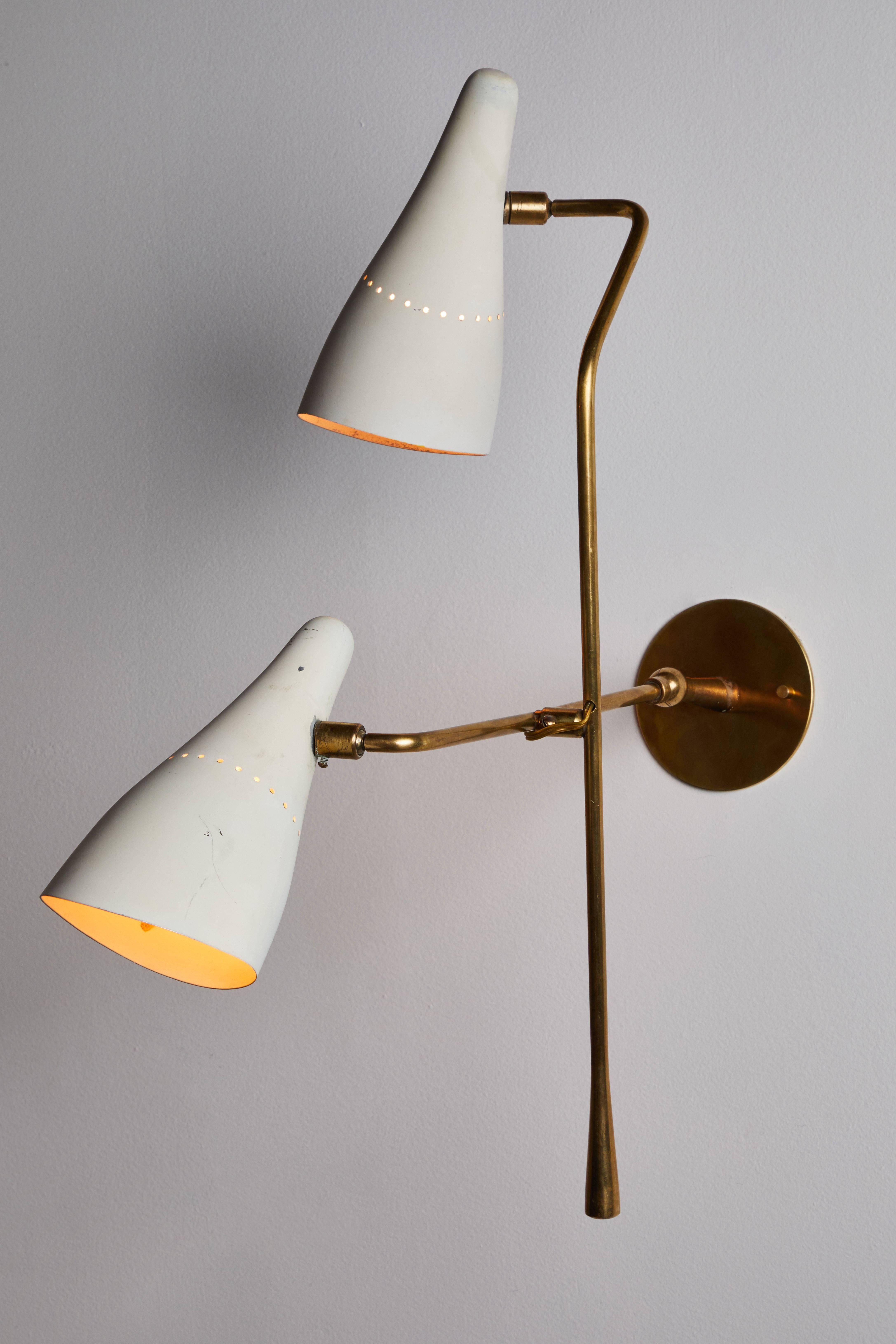 Rare double shade wall light by Lumen. Designed and manufactured in Italy, circa 1950s. Enameled metal and brass. Shades pivot up/down and left/right by ball joint. Height of fixture can be adjusted by brass lever. Rewired for US junction boxes.