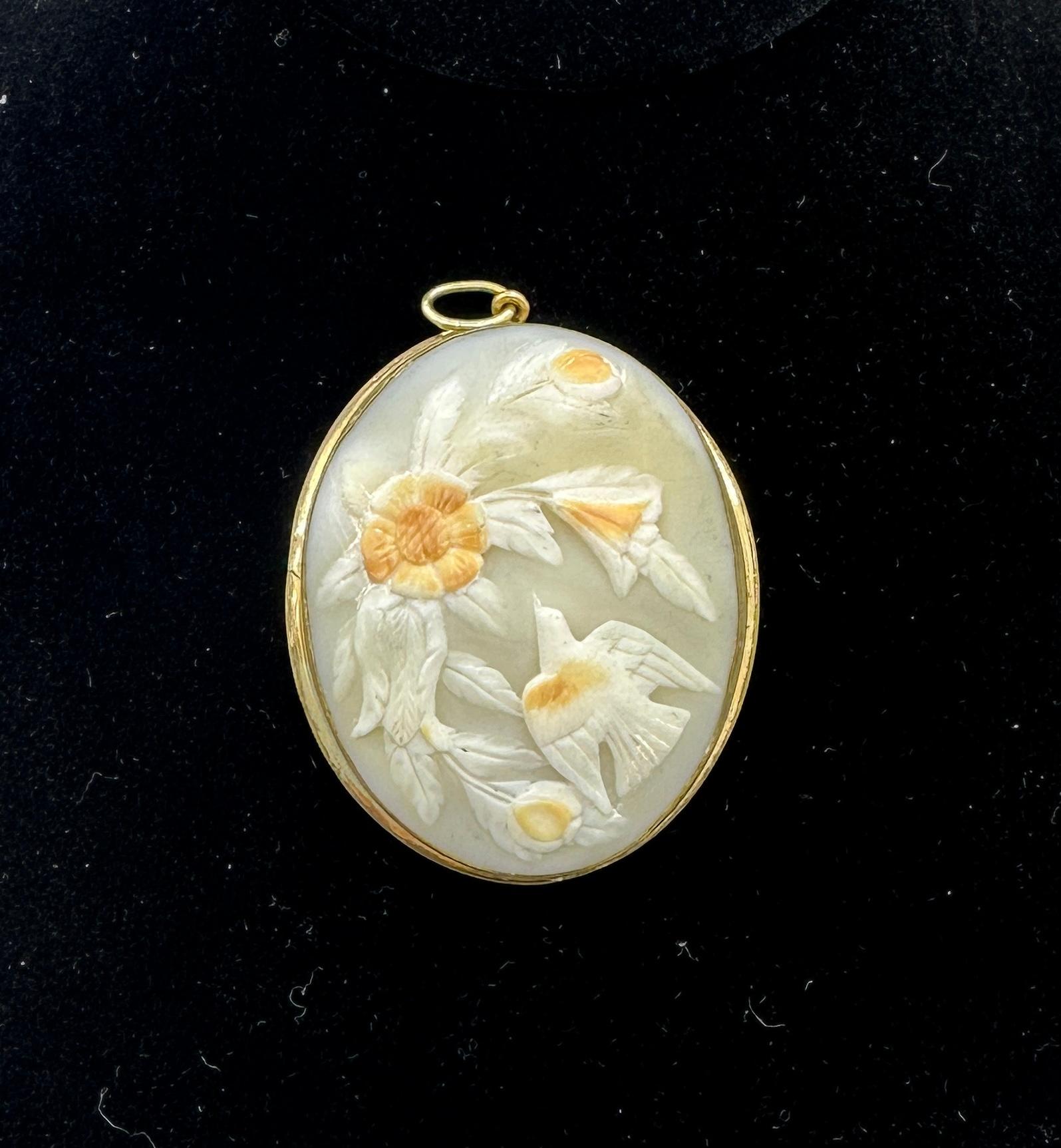 This is an absolutely stunning and very rare antique Victorian Cameo Pendant with a high relief carving of a Dove Bird flying towards a stunning Flower Bouquet of extraordinary beauty.  The Cameo is the work of a master artisan and the motif with