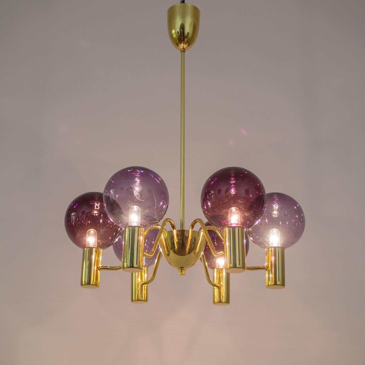 Lovely model T 372/6 chandelier by Hans-Agne Jakobsson from the 1960s. This is a particular rare version with glass globes in two colors—one a deep Bordeaux and the other in a light purple. The chandelier is wired with two circuits allowing the two