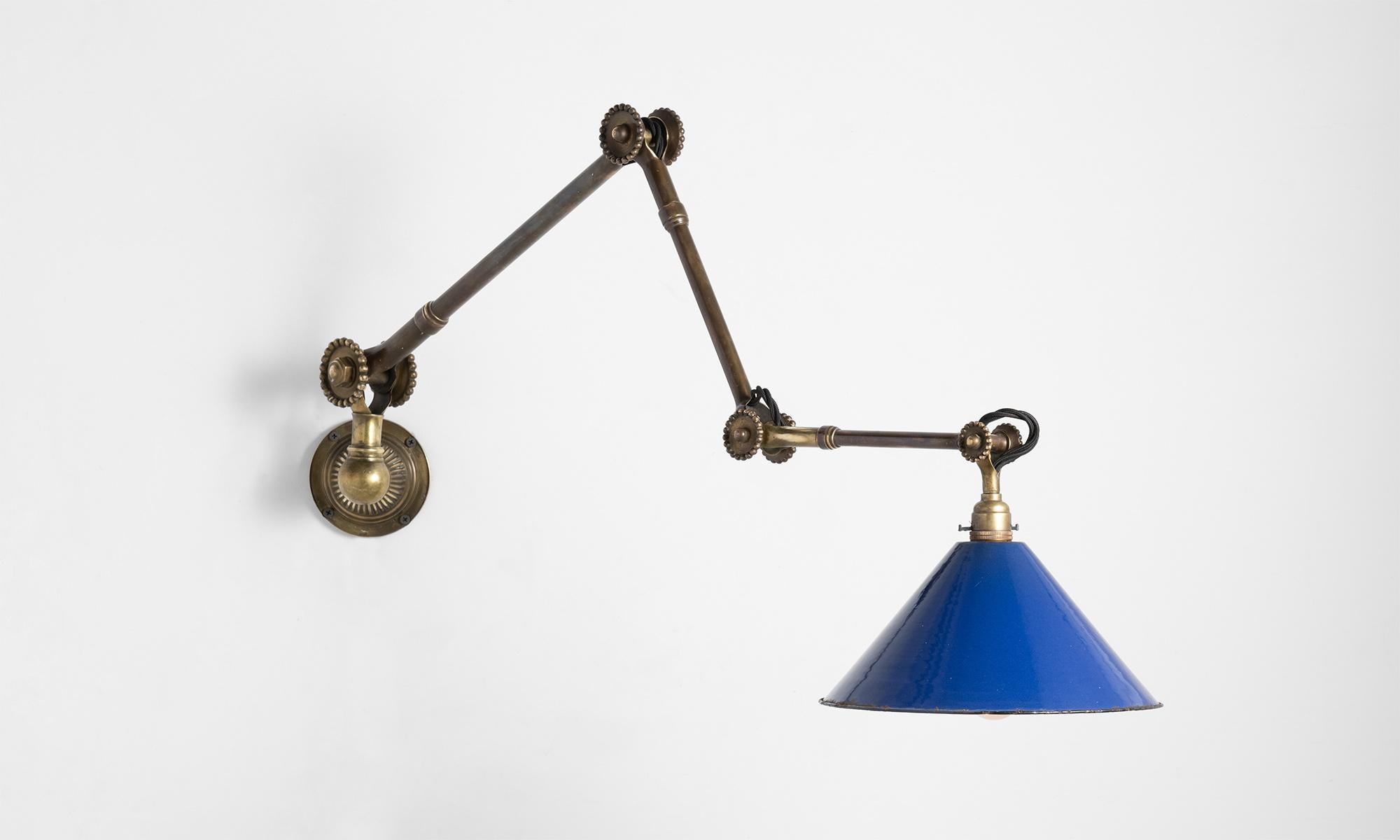 Large-scale articulating light with Daisy joints, blue shade and makers mark stamped into the base. Can be mounted to the wall, or to a desk.