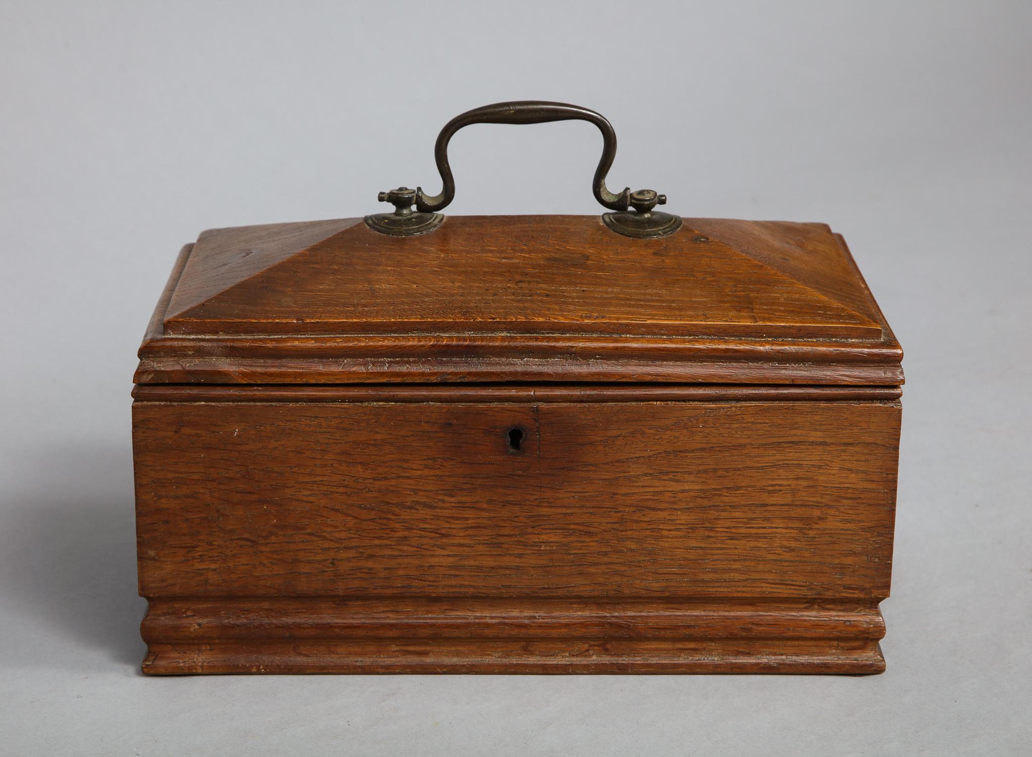 Most unusual Georgian oak tea caddy fashioned from a single block of timber, hollowed out from the inside, retaining original gilt lacquer brass handle and iron lock, the whole with pleasing patina.