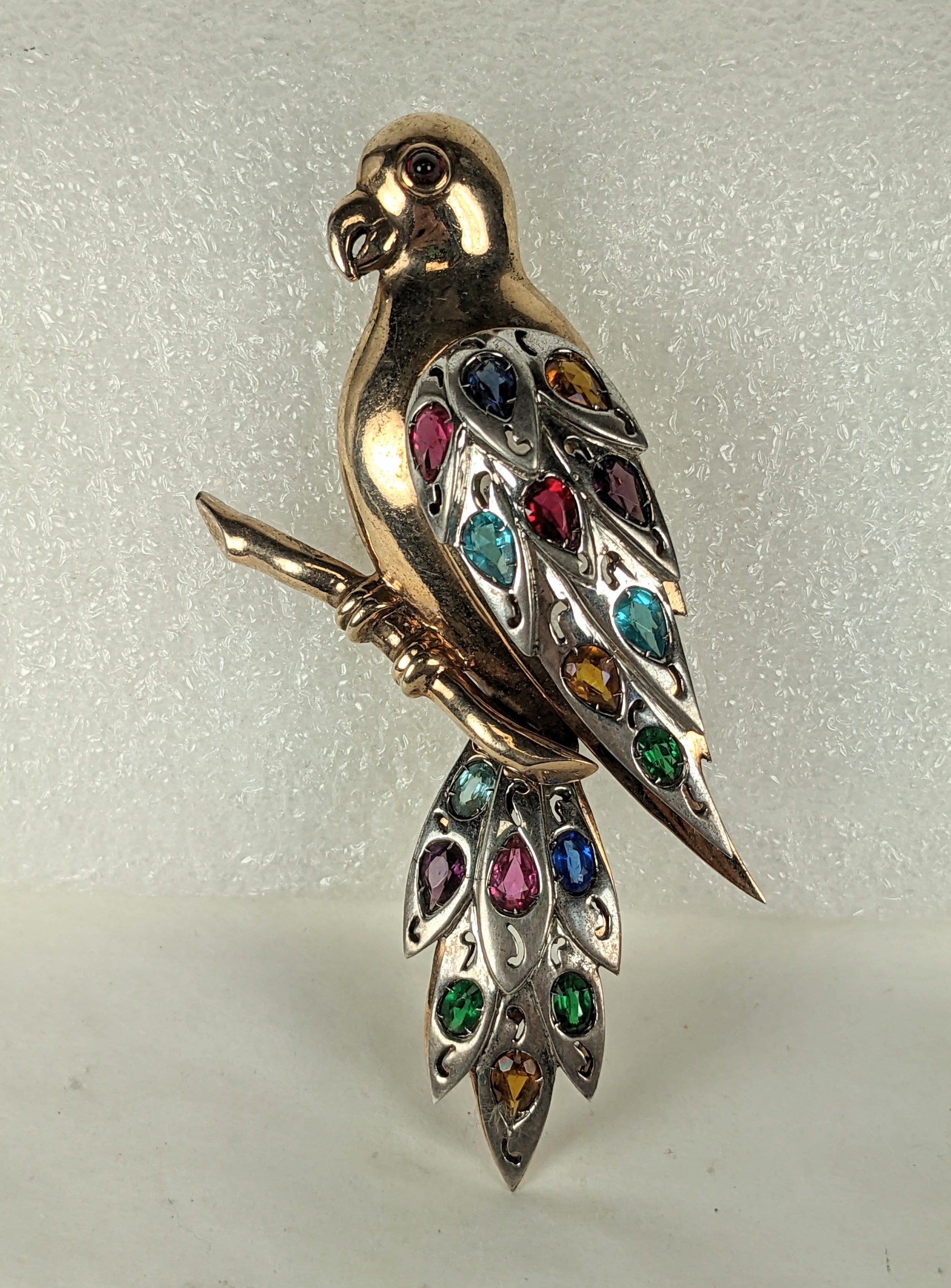 Rare and large Dujay Dimensional Parrot set in sterling silver from the 1940's. Made in 2 layers with pink gold vermeil finish on body and unplated sterling on feathers, hand set with multi colored pastes and faux ruby eye. Dujay pieces are unsigned