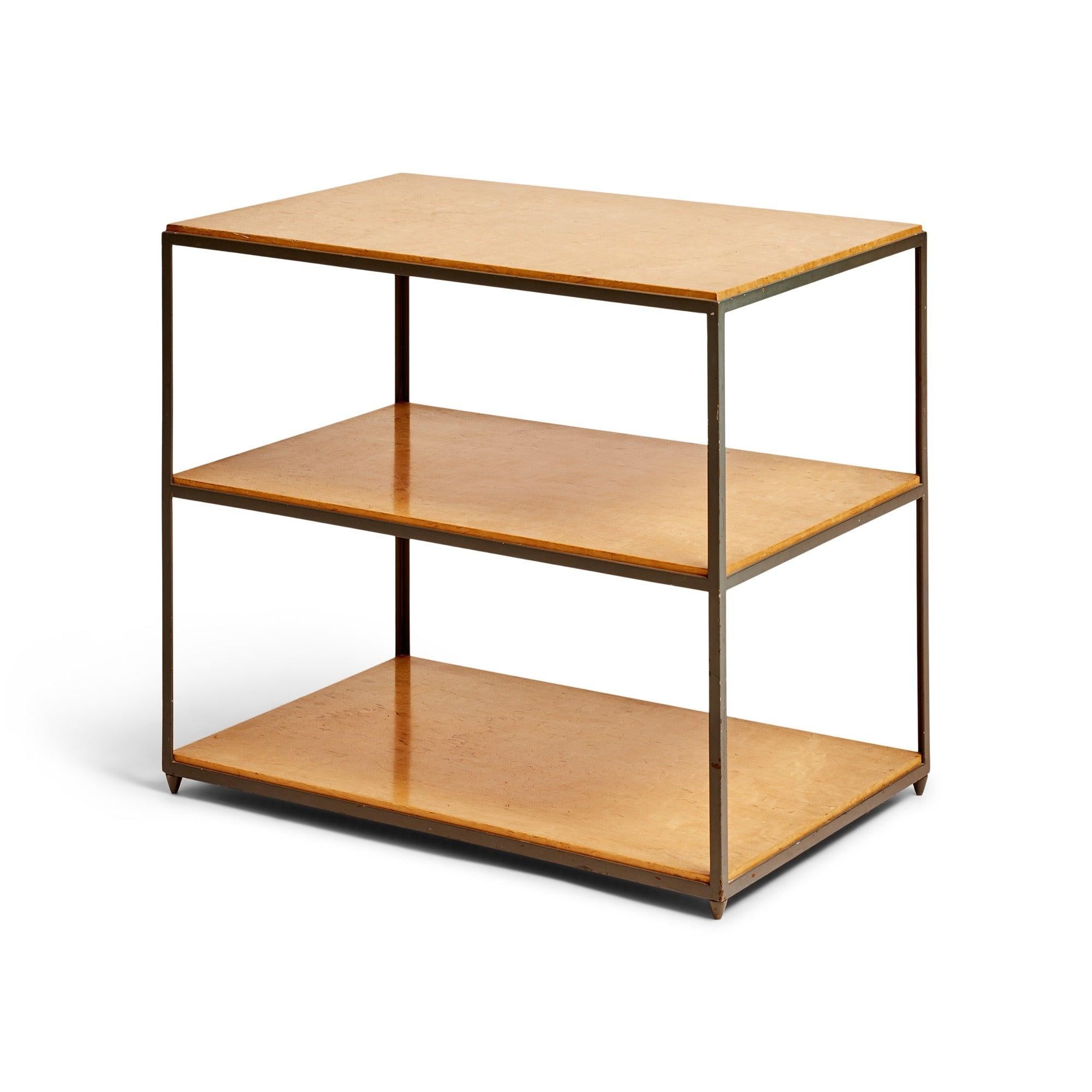 Three Finnish birch burl shelves set in a frame of thin, square steel with a baked enamel finish raised on four, tapered steel nubs serving as inconspicuous legs. This model, 4611, is part of a small series of five architecturally inspired