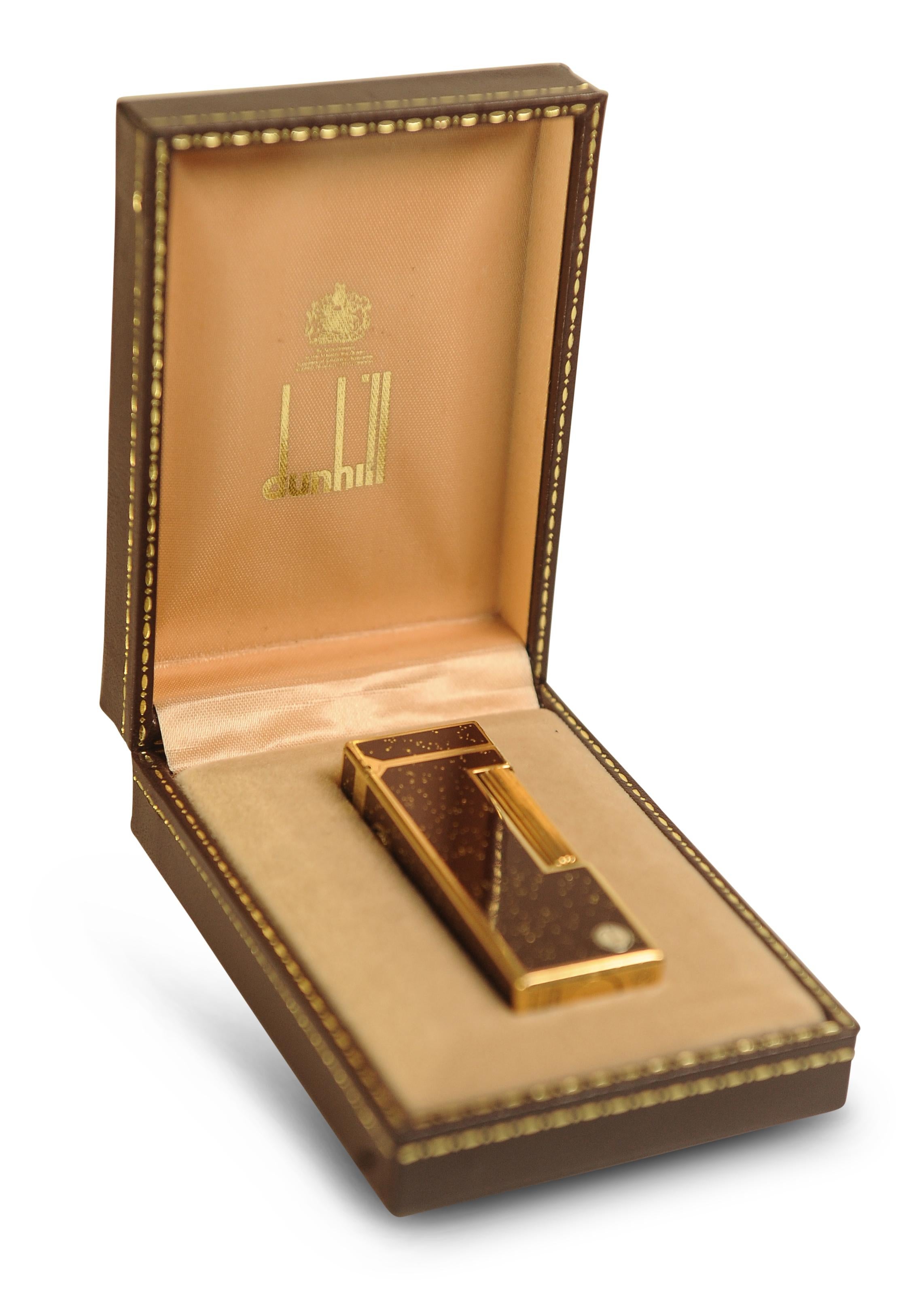 Rare Dunhill Rollagas Bordeaux Gold Dust Cigarette Lighter With Original Dunhill Box Complete With Guarantee Card 

Made in Switzerland 

The Rollagas was first developed in 1953 as a limited-edition model. 
Conrad Zellweger designed the Rollagas,