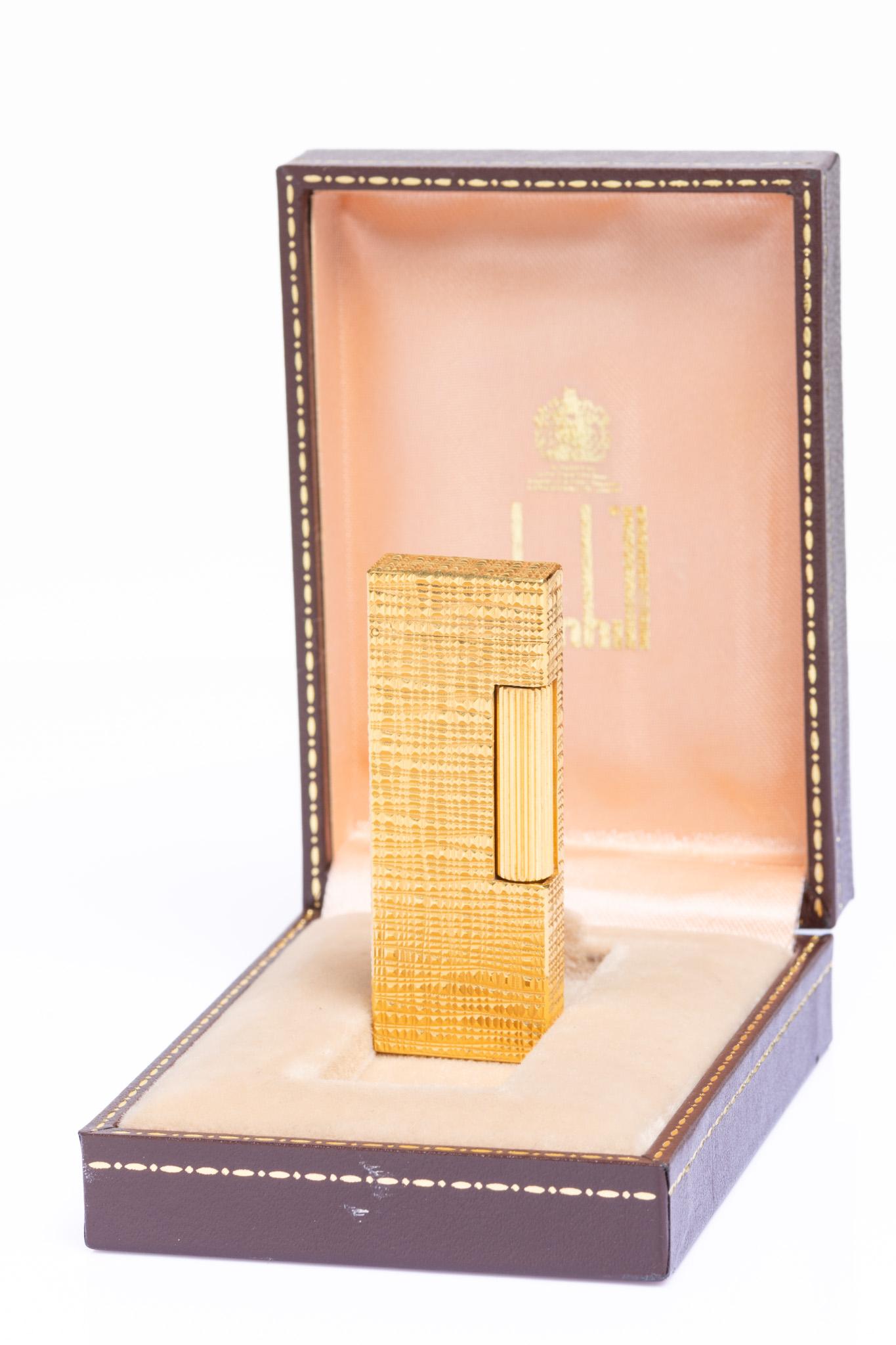 Very rare gold plated Dunhill Rollagas Lighter with an unusual pattern. The lighter is in excellent condition and was hardly ever used. It comes with an original Dunhill box and all the documents, together with blue Dunhill lighter flints—an iconic