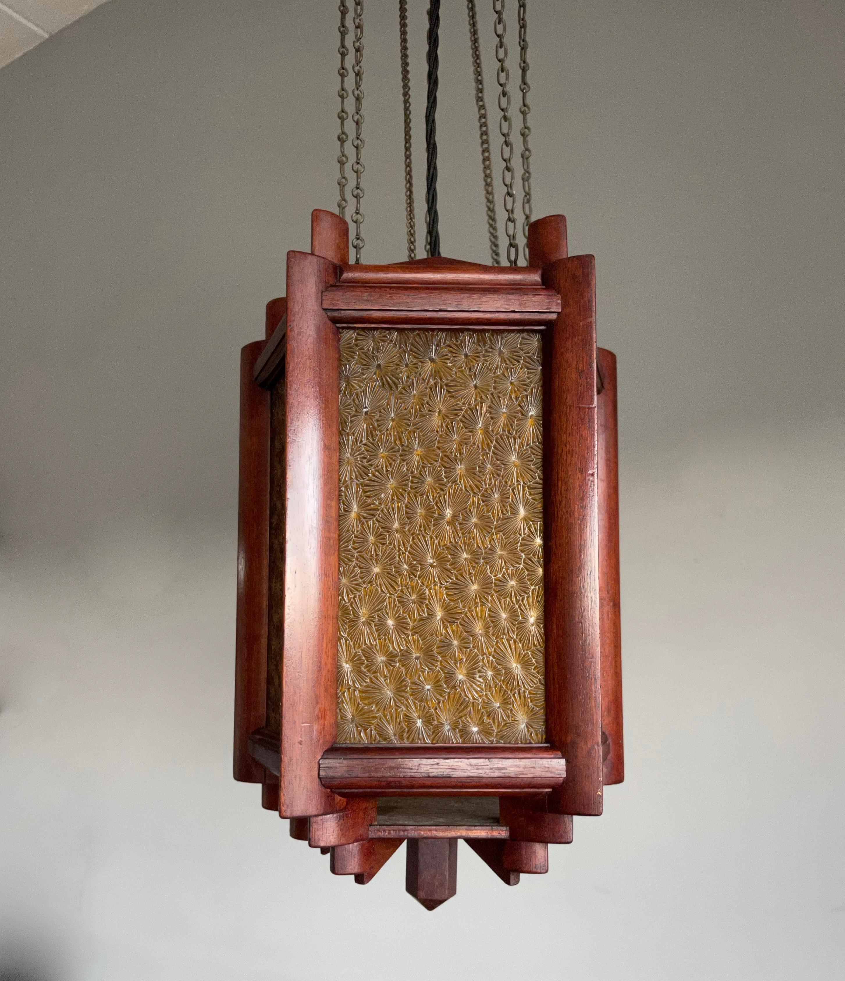 Mint condition, perfectly geometrical handmade Arts and Crafts lantern, ceiling light.

Finding rare or unique light fixtures always makes our day and when we came across this handcrafted wooden pendant we were immediately 'sold'. The calm and