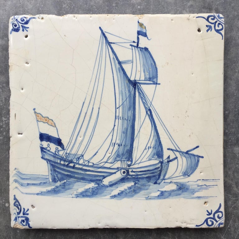The Netherlands
Amsterdam
1640 - 1680

A rare and Fine painted tile with a sailing Yacht. This tile is exceptional and one of the rarest to find: with colored flags. Both in the top and on the stern we see the Dutch Flag. 

This tile has been