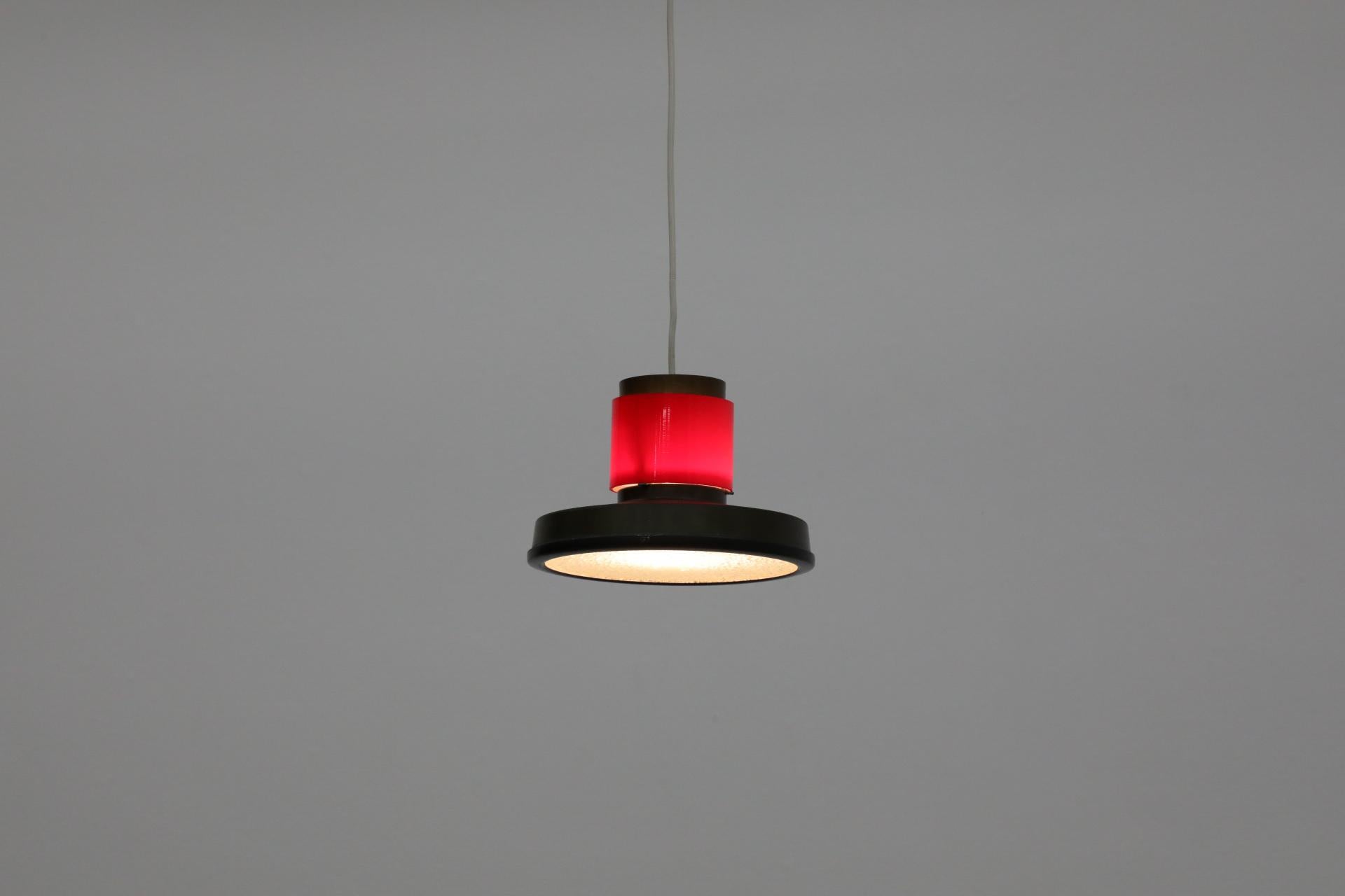 Rare Dutch Mid-Century pendant with red glass ring by famed lighting manufacturer Hiemstra Evolux. In business as Hiemstra Evolux from 1960 to 1975 after having been established in 1934 by Niek Hiemstra and his brother-in-law as Hiemstra & Evenblij,