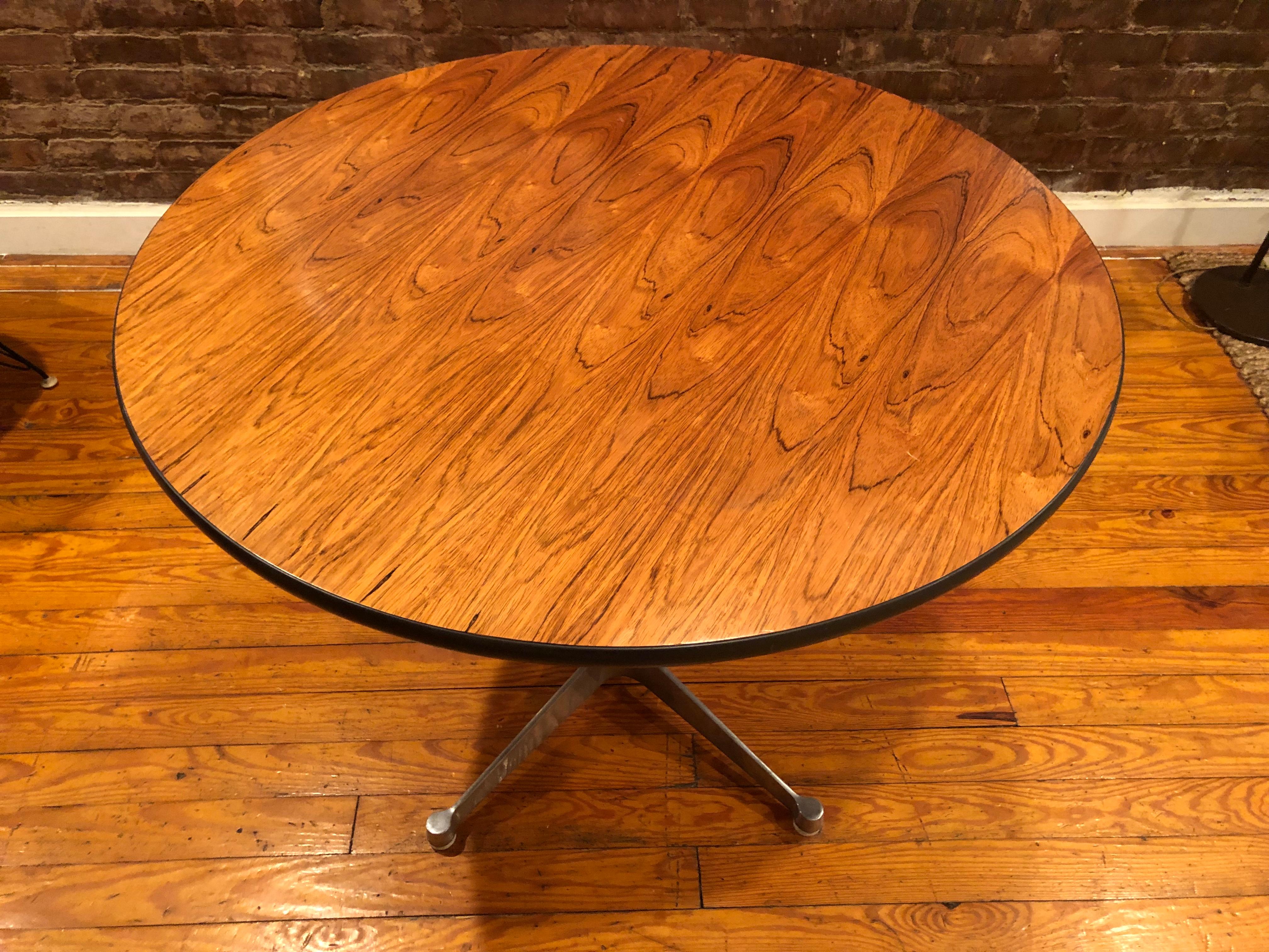 Gorgeous and supremely rare Herman Miller 36 inch dining table in Brazilian rosewood (this wood was discontinued in 1993 due to environmental regulations). The grains are absolutely spectacular and highly figured. The polished aluminum contract base