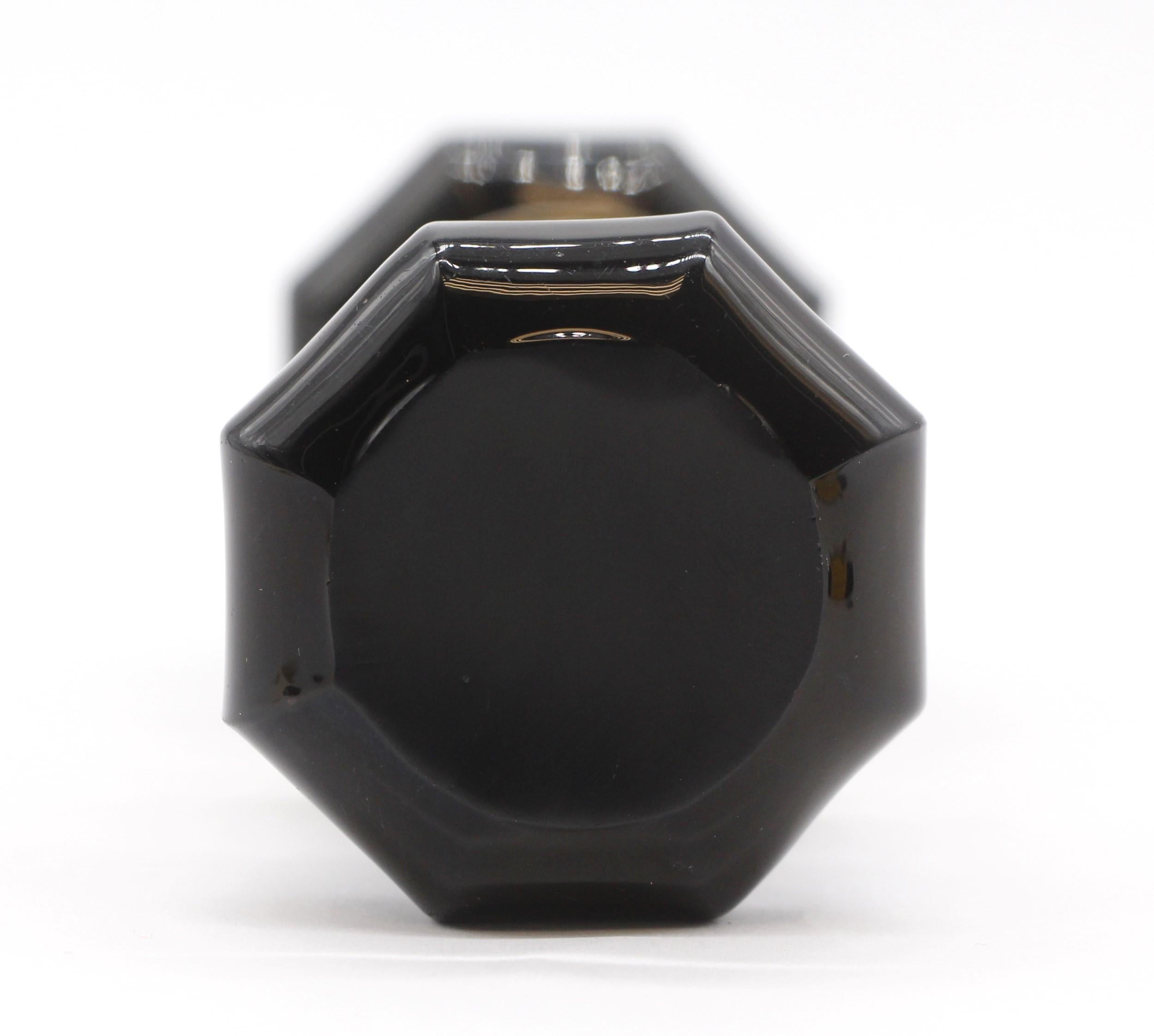 This early 1900s, octagon shaped black glass doorknob set is extremely rare.  They have have a brass shank and come complete with the original brass rosettes. This is a collectors item.  Priced as a set. Please note, this item is located in our