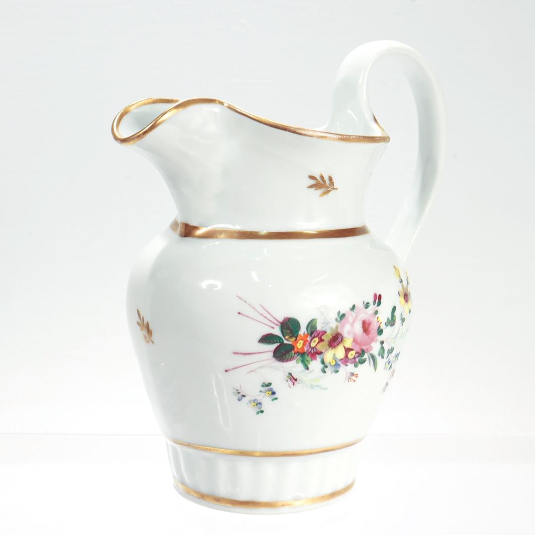 A fine and rare, early 19th century Tucker and Hemphill porcelain pitcher. 

Of classic form with typical polychrome floral sprays to both sides and gilt decoration. 

Tucker and Hemphill was the important first large-scale producer of porcelain in