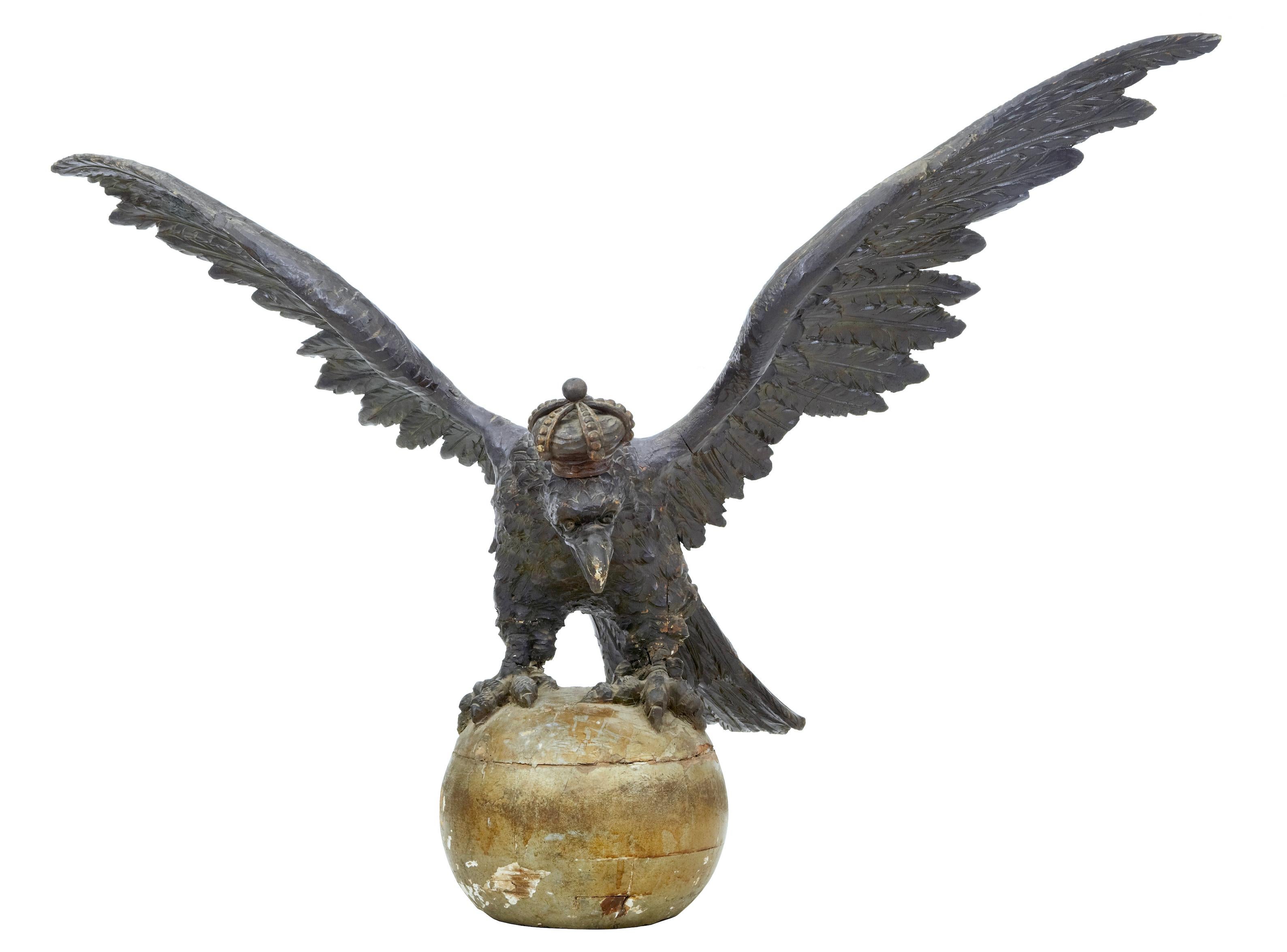 Rare early 19th century carved Hapsburg decorative eagle, circa 1820.

Stunning carved German Hapsburg eagle standing on giltwood ball. Profusely carved in linden wood and in near original condition. Eagle posing in a menacing position with a