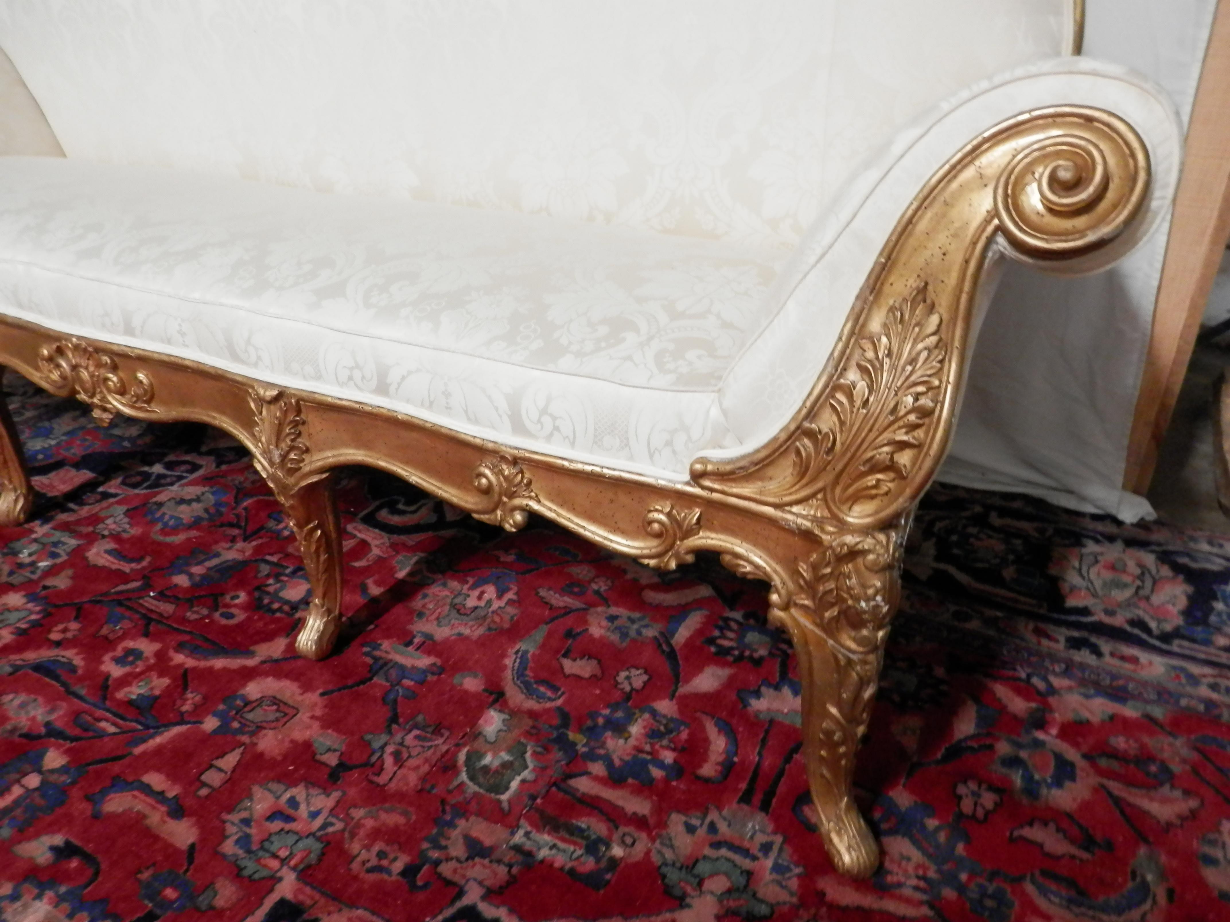 Early 19th century Italian Louis XV gilt carved sofa. Beautifully carved with original gilding. Covered in a cream upholstery with floral detail.