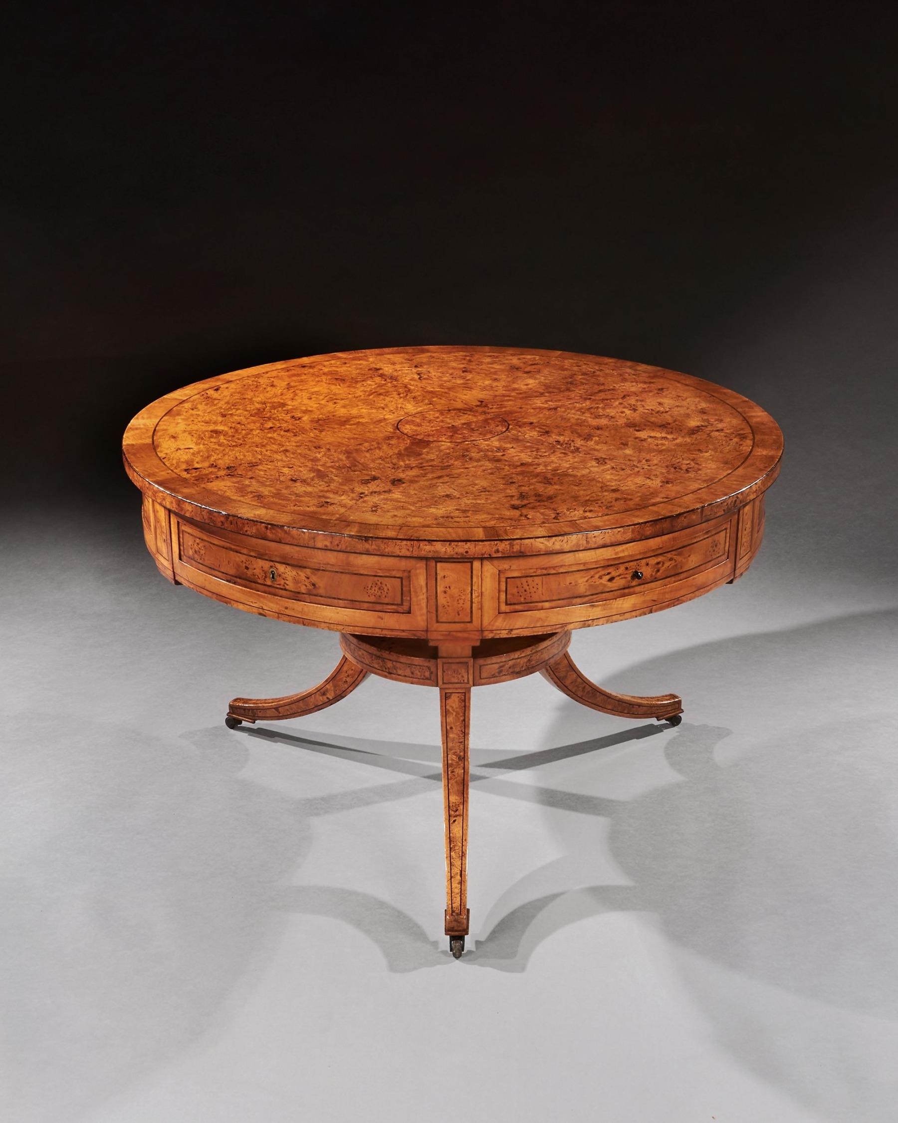 An elegant and rare early 19th century burr root maple drum top table on splayed triform base.


Scandinavian circa 1820.

The circular top with rarely seen figured root maple segmented veneer and central roundel inlaid with fine ebonised and