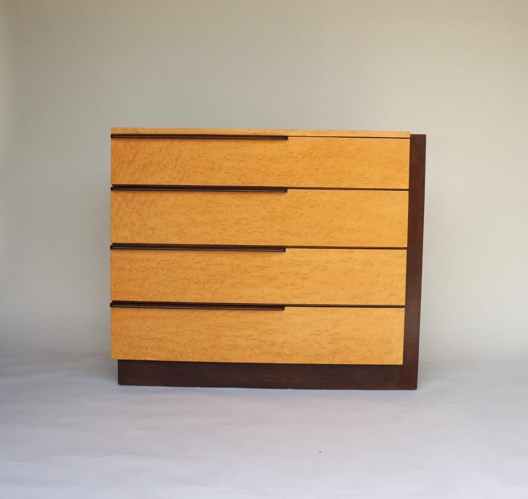 Rare birdseye maple and mahogany dresser by Gilbert Rohde for Herman Miller, circa 1940's. This asymmetrical dresser has the perfect balance of mid century modern simplicity and the fine craftsmanship and rich materials characteristic of the Art