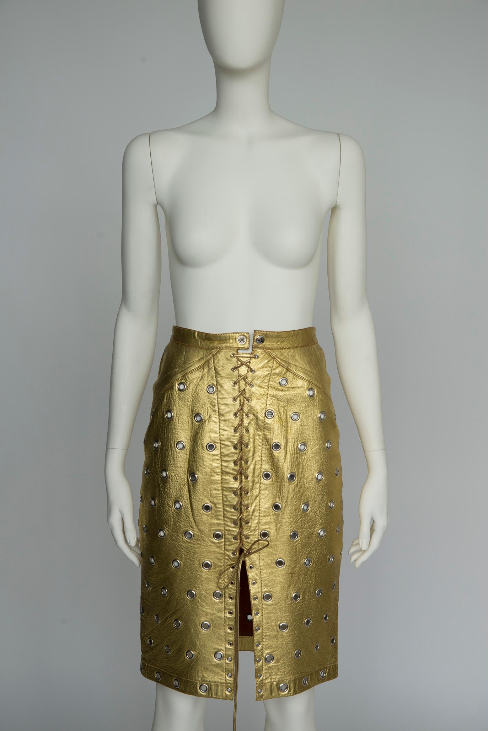 Worldwide known, admired and revered for his intuitive comprehension of the female body, Azzedine Alaïa never ceased to highlight women. Crafted from supple gold leather with his signature eyelet embellishments, this rare 80s skirt (probably from