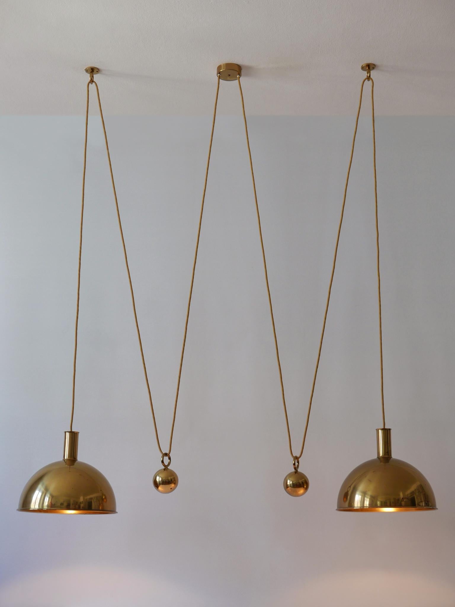Extremely rare and early solid brass double counterweight pendant lamp or hanging light. Designed and manufactured by Florian Schulz, Germany, 1960s.

Executed in solid brass, the lamp comes with 2 x E27 Edison screw fit bulb holder, is wired and