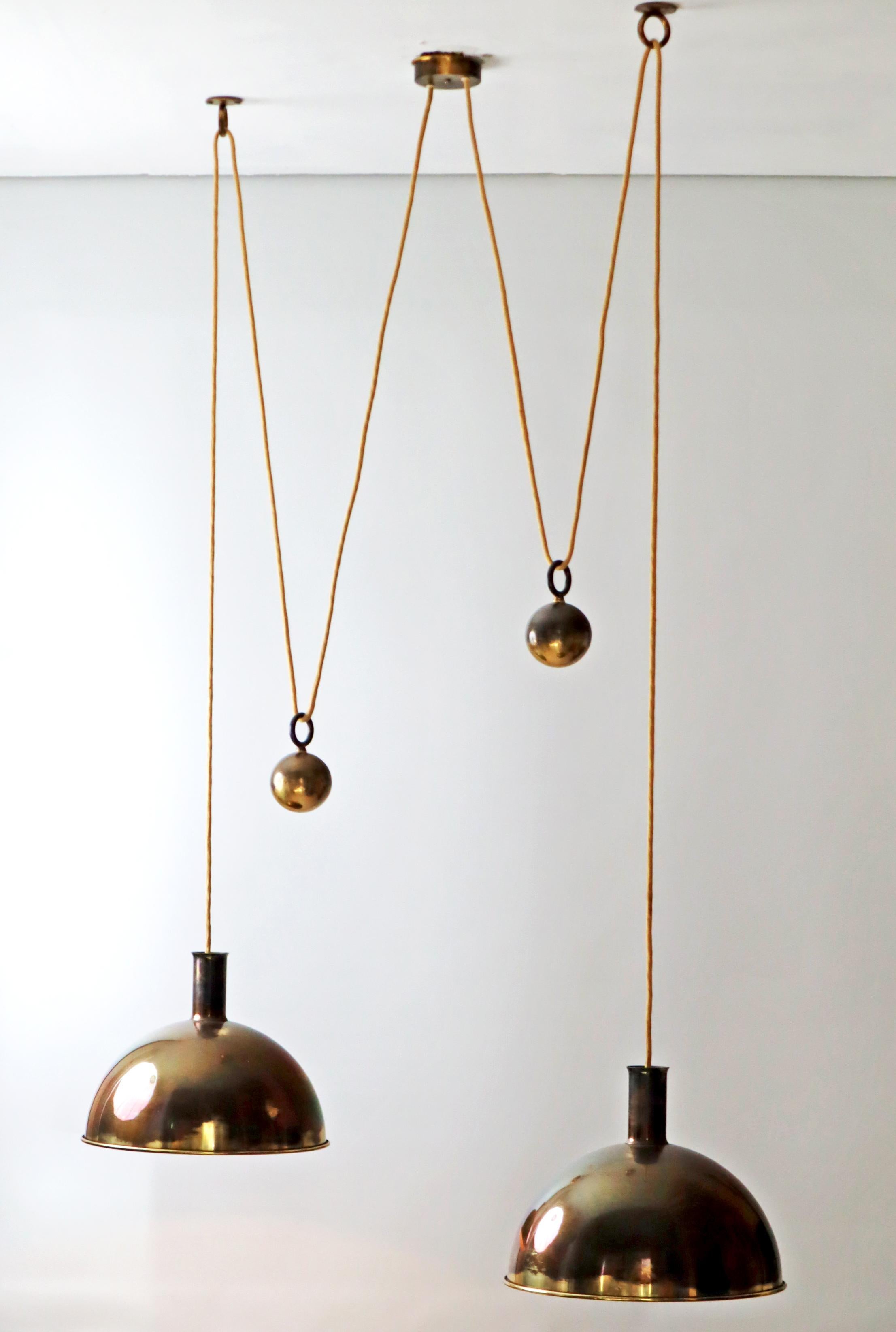 Florian Schulz, a term for craftsmanship and design that is reduced to the essentials. With this extremely early and rare double Posa by Florian Schulz you get something special, a double Posa with a beautiful patina characterizes the lamp, the