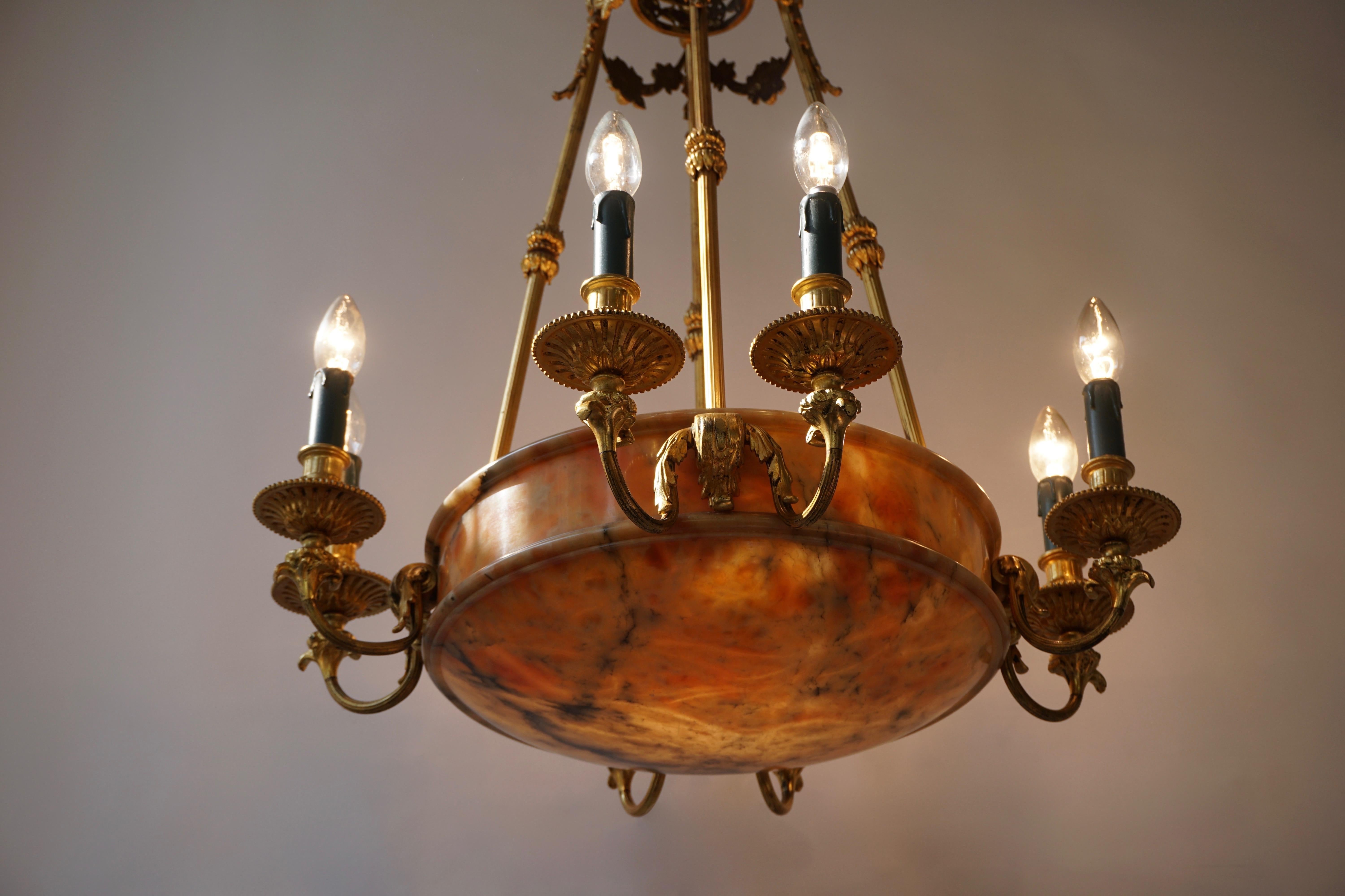 A large and rare early French 20th century Art Deco bronze alabaster eight-light chandelier.
Measures: 
Height fixture 87 cm.
Total height 100 cm.
Diameter 65 cm.
Twelve bulbs with an E14 fitting.