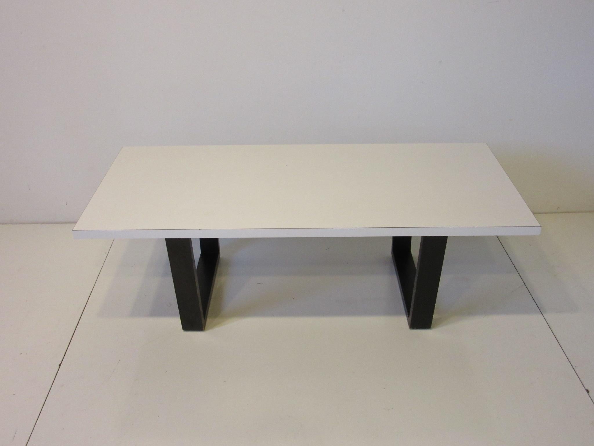 A early and rare Nelson coffee table / bench with white rectangle Laminate top having black legs typical of the Nelson slat bench coffee table. This table was not produced in large numbers for retail sale and was purchase in Zeeland Michigan from a