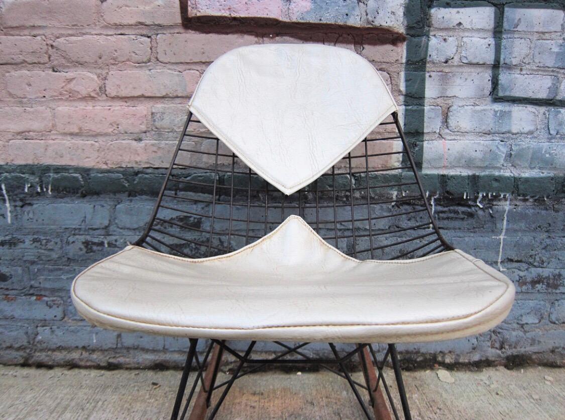 Rare early example of the Eames RKR-2 wire rocking chair with bikini pads for Herman Miller, circa early 1960s with original pads and Herman Miller label. Original walnut rockers with exceptional patina.