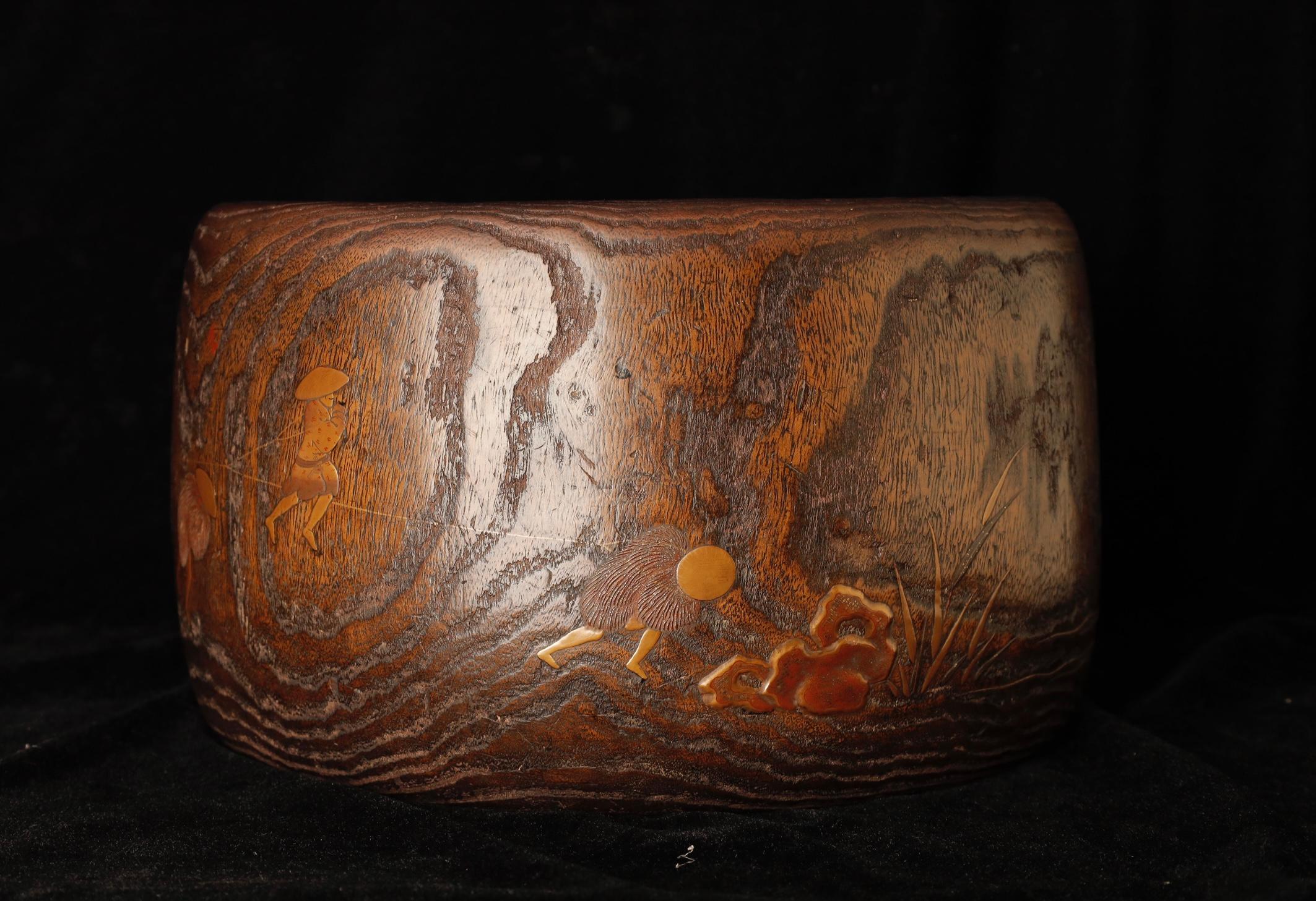 An exceptional and rare example of an early Japanese hibachi (charcoal brazier), this elegant piece is crafted from kiri wood (paulownia) and fitted with a beautifully aged copper insert. What sets this hibachi apart is its unique makie lacquer