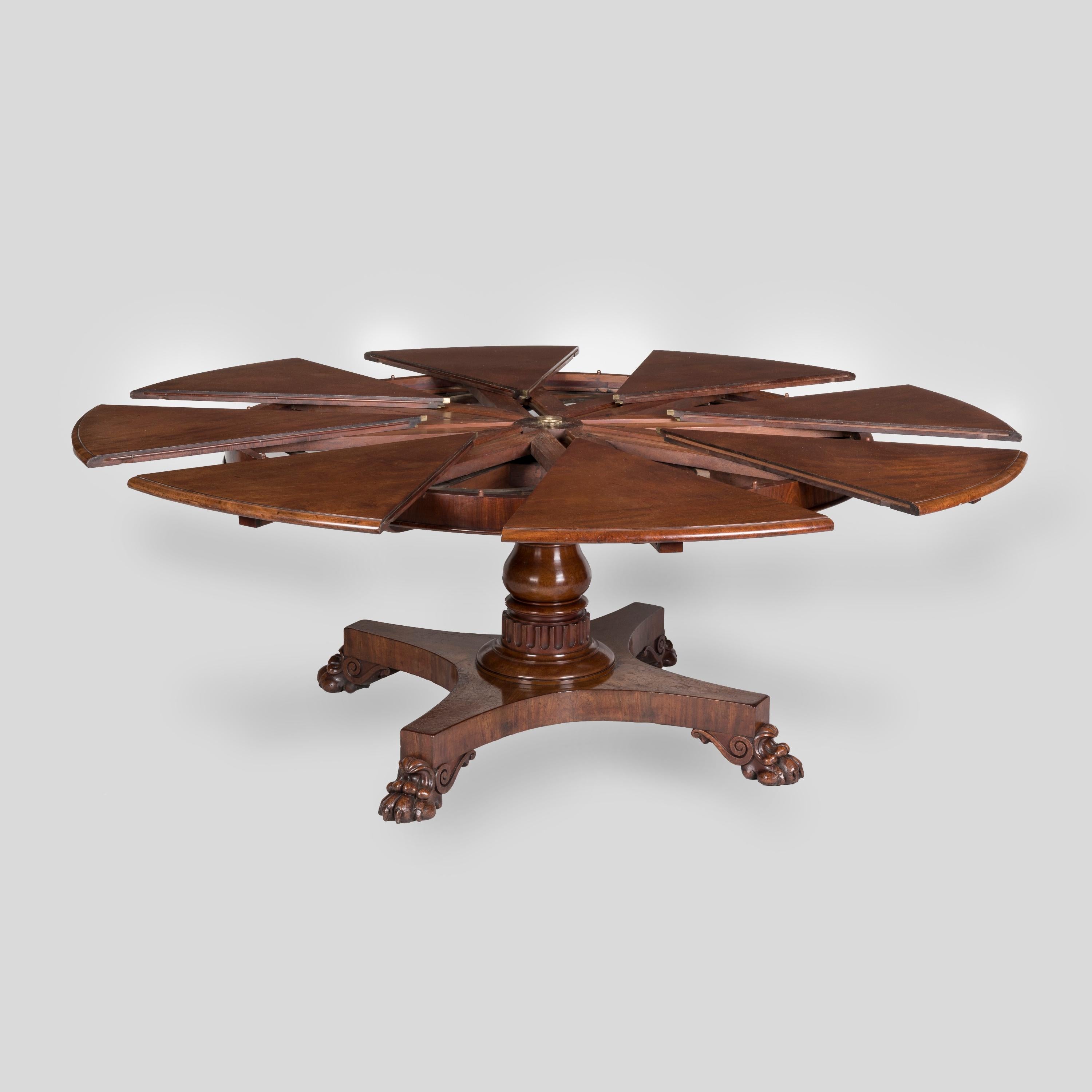 A Rare 'Jupe's' Extensible Mechanical Action Circular Dining Table
By Johnstone & Jeanes of New Bond Street

Together with its original Leaf Cabinet
By Johnstone & Jeanes

Constructed in mahogany, rising from four 'lions paw' feet joined by an