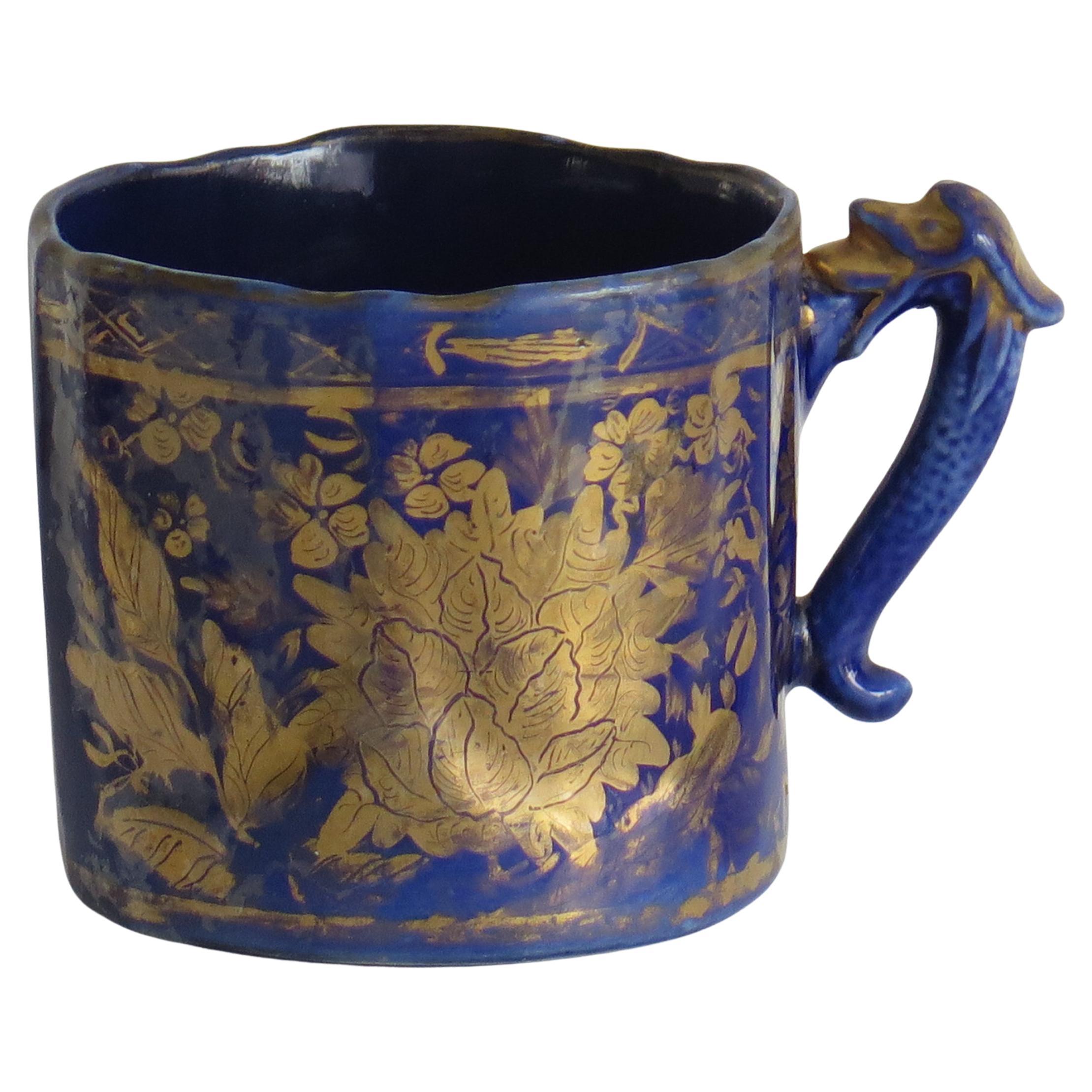 This is a rare, Ironstone pottery mug in the Gold Posies and Butterflies pattern, made by Mason's Ironstone, of Lane Delph, Staffordshire, England, circa 1818

Early Mason's ironstone mugs are rare. This mug has a vertically fluted shape, a