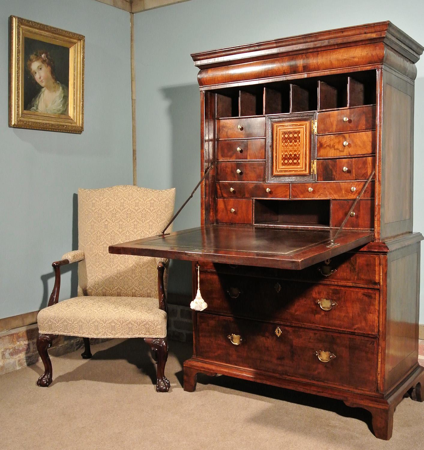 A very rare walnut scriptor of small proportions and with a most attractive figuring and colour.

The scriptor has beautiful and original marquetry inlays to the fall and interior door and the fall and each of the drawers have double featherbanded