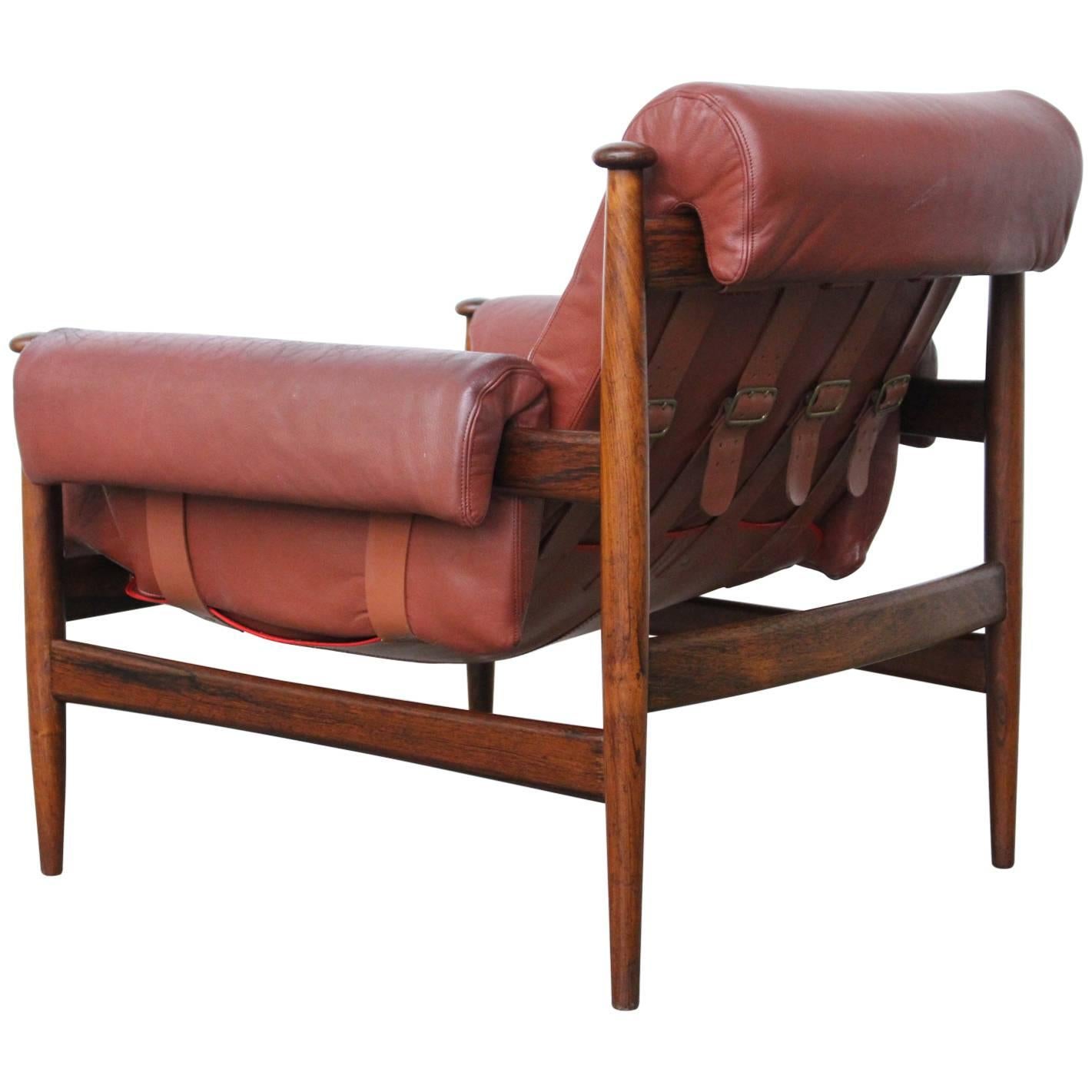 Beautifully sculpted lounge armchairmodel Amiral by Erik Merthen for Ire Møbler, Sweden, 1964. Made of solid rosewood and thick Bordeaux-red leather cushions, all in excellent condition. The tension of the backrest is variable by means of buckled