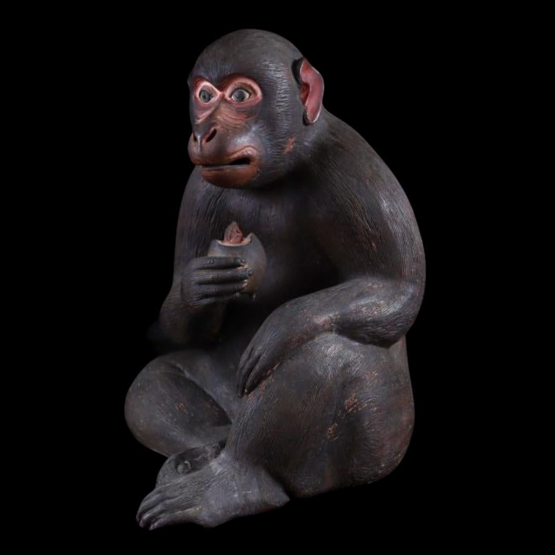 This exceptional Edo-period sculpture depicts a seated monkey in an incredibly lifelike manner, with finely carved details and expressive features. Made using traditional Dojin-yaki (土人形) or regional folk pottery techniques, this piece showcases the