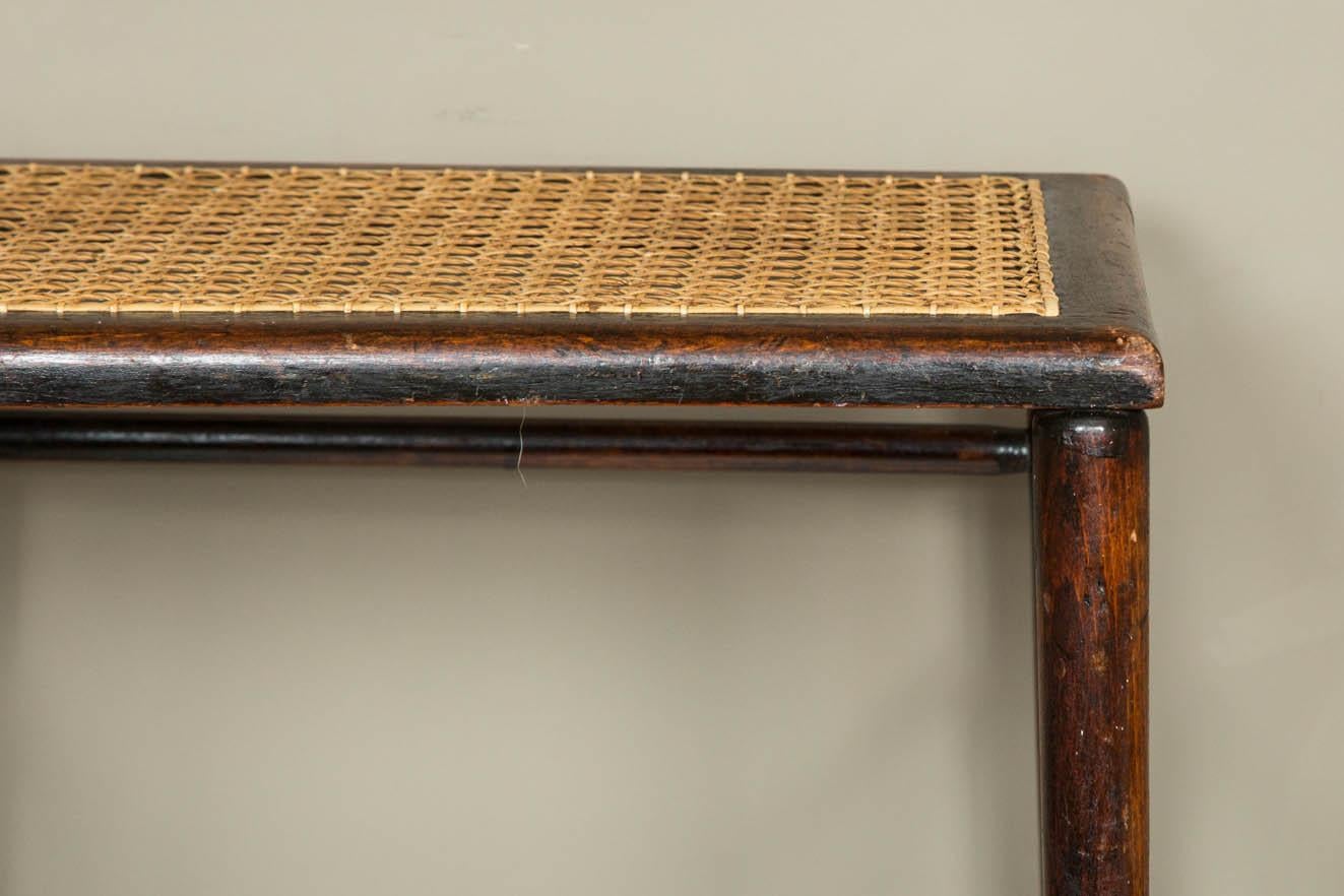 A beech wood and caned stool used in Westminster Abbey at the Coronation of King Edward VII and Queen Alexandra on 9 August 1902. With rectangular cane seat and turned tapering legs joined by multiple stretchers, stamped E.R VII (with crown)
