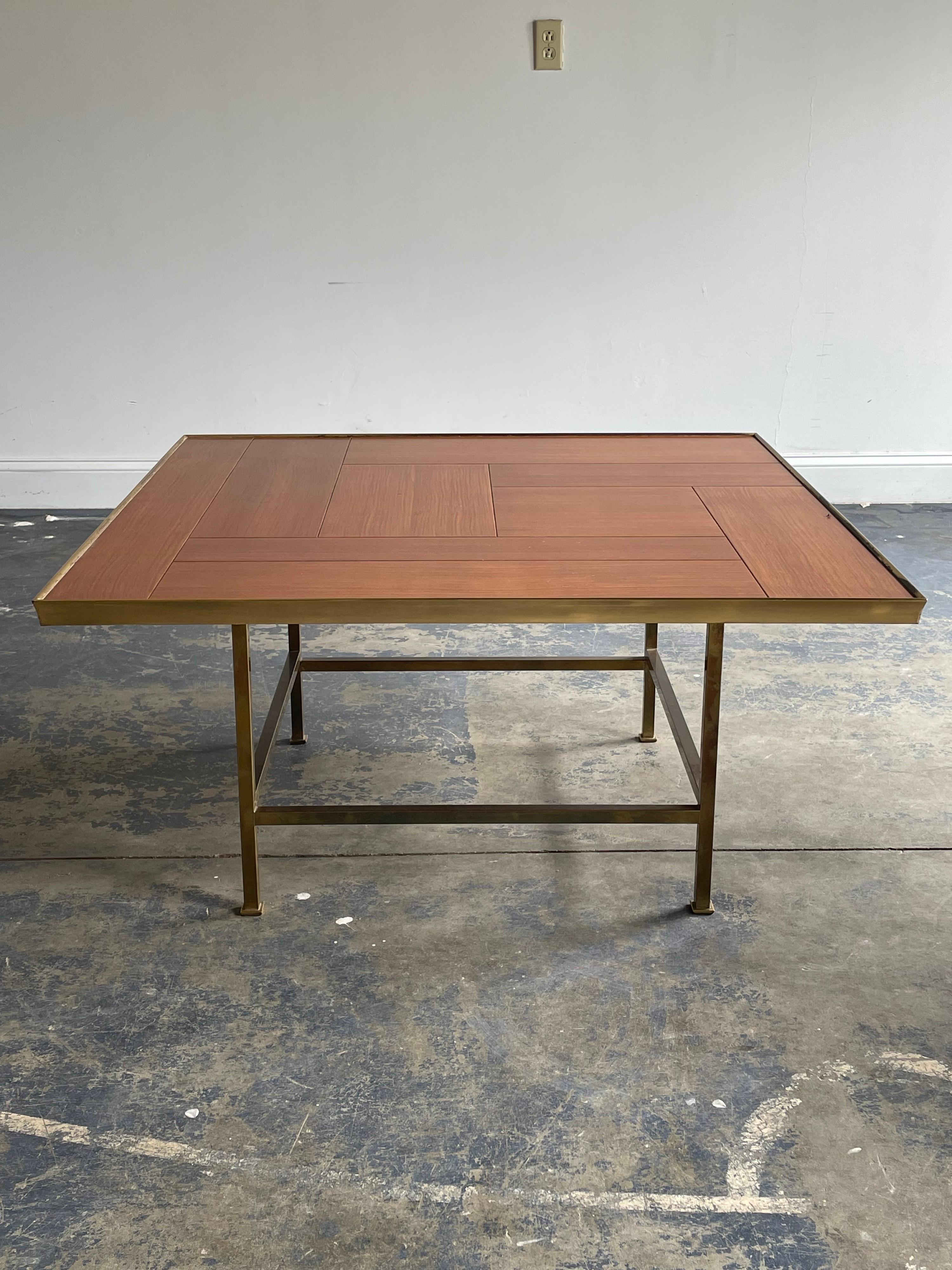 A stunning and scarce coffee table designed by Edward Wormley for Dunbar. Features a geometric wood top with brass frame and brass base.

Would work well in a variety of interiors such as modern, mid century modern, contemporary, etc. Piece blends