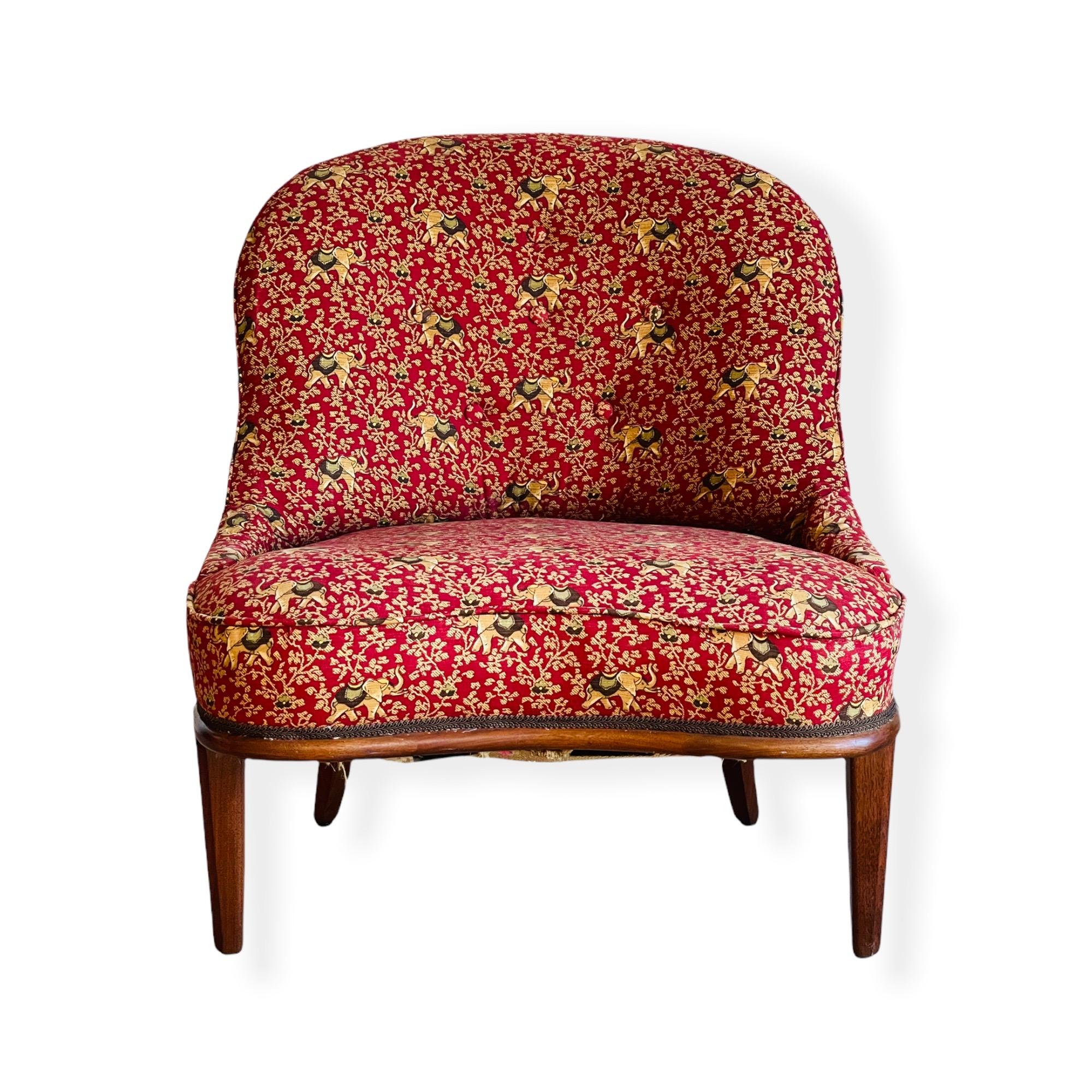 This amazing Edward Wormley Style Slipper chair is a show stopper. Solid mahogany frame and legs with original floral and elephant pattern fabric. This chair is in good vintage condition with normal wear consistent with age and use. 

Measures: W