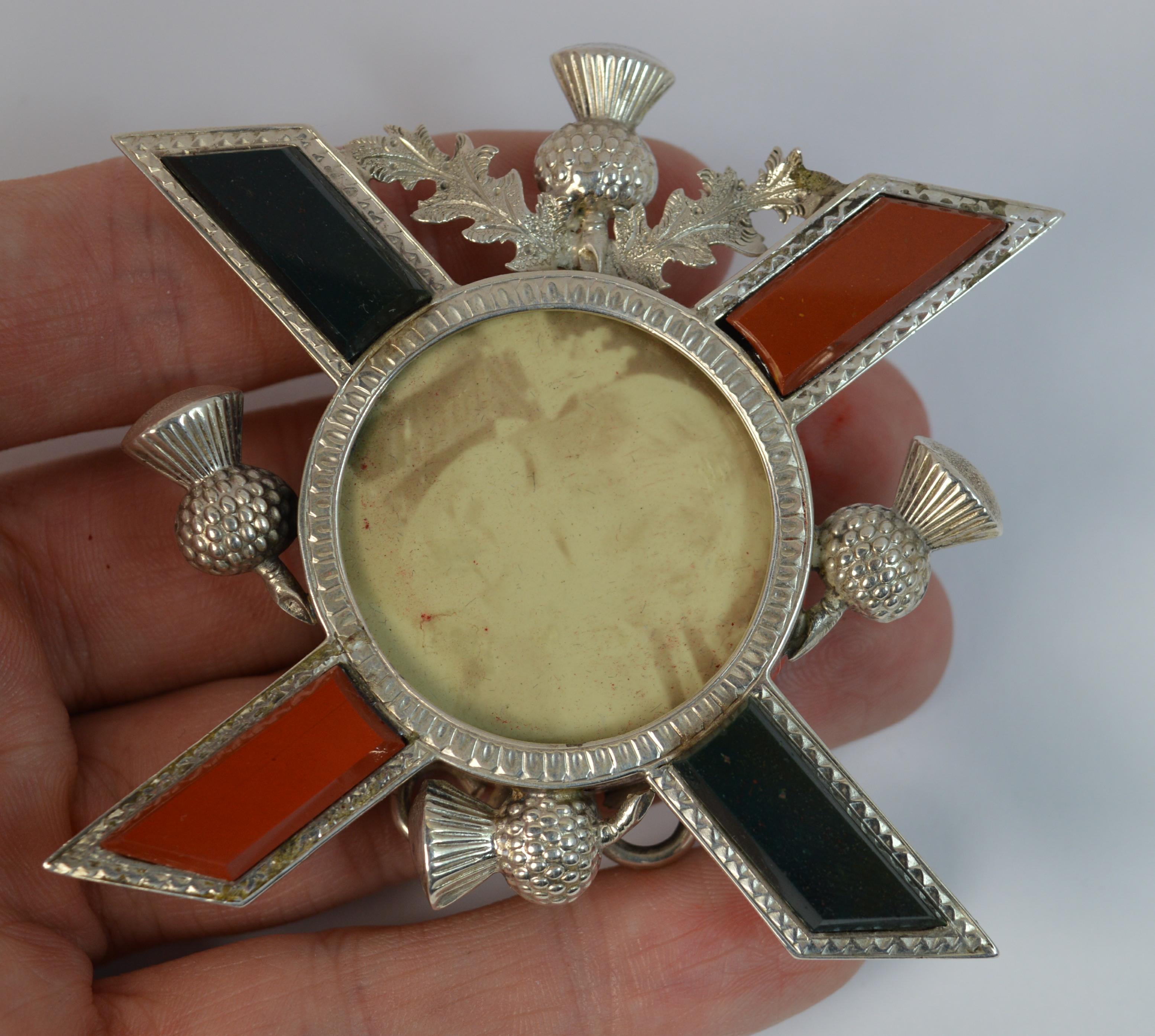 A fine quality sterling silver photo frame of Edwardian era.
Sterling silver example with Scottish thistle design throughout and cross pattern set with two bloodstones and two carnelians. 
Unusual shape and design.

Hallmarks ; lion, Birmingham