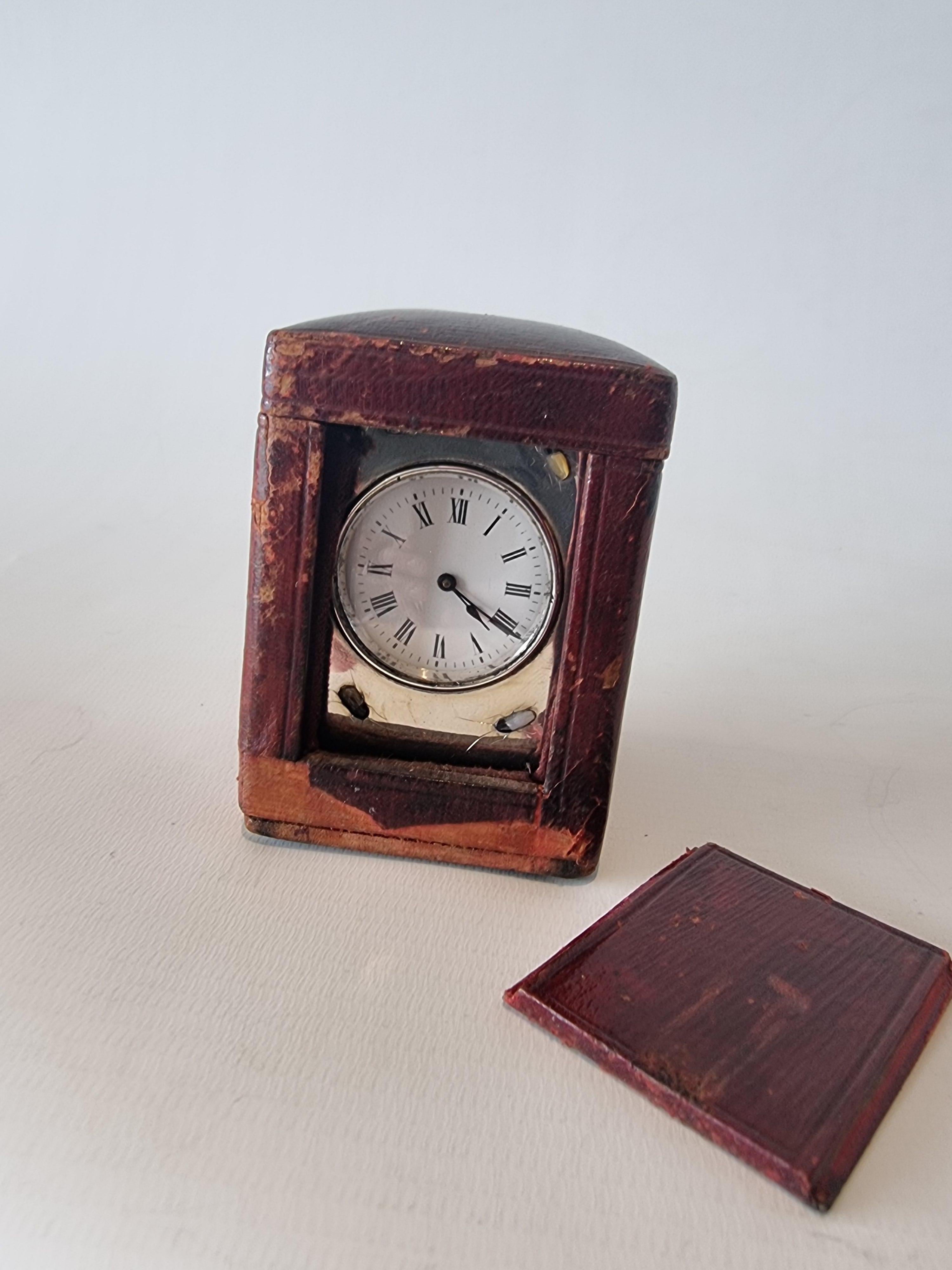 Silver and Shibayama miniature carriage clock in original leather carry case. Exceptional Shibayama work on the silver case with carved semi precious stones. White enamel dial with roman numerals. The fine movement is of 8 day duration and regulated